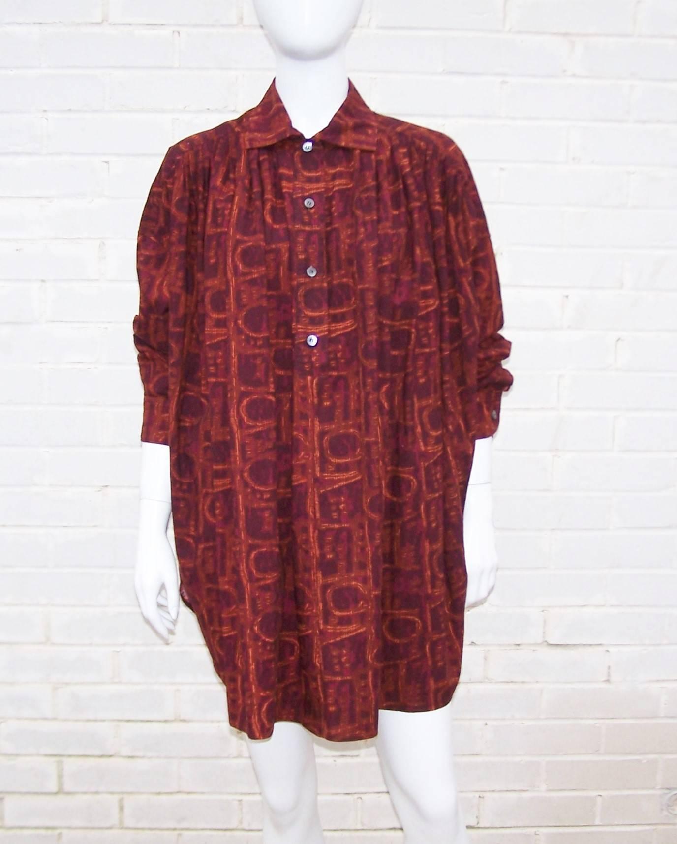 This 1980's design from the Italian firm, Callaghan, combines a voluminous smock top silhouette with an amazing cotton fabric that incorporates rich dark burgundy, brown, red and orange colors with a tribal motif.  The top buttons half way at the