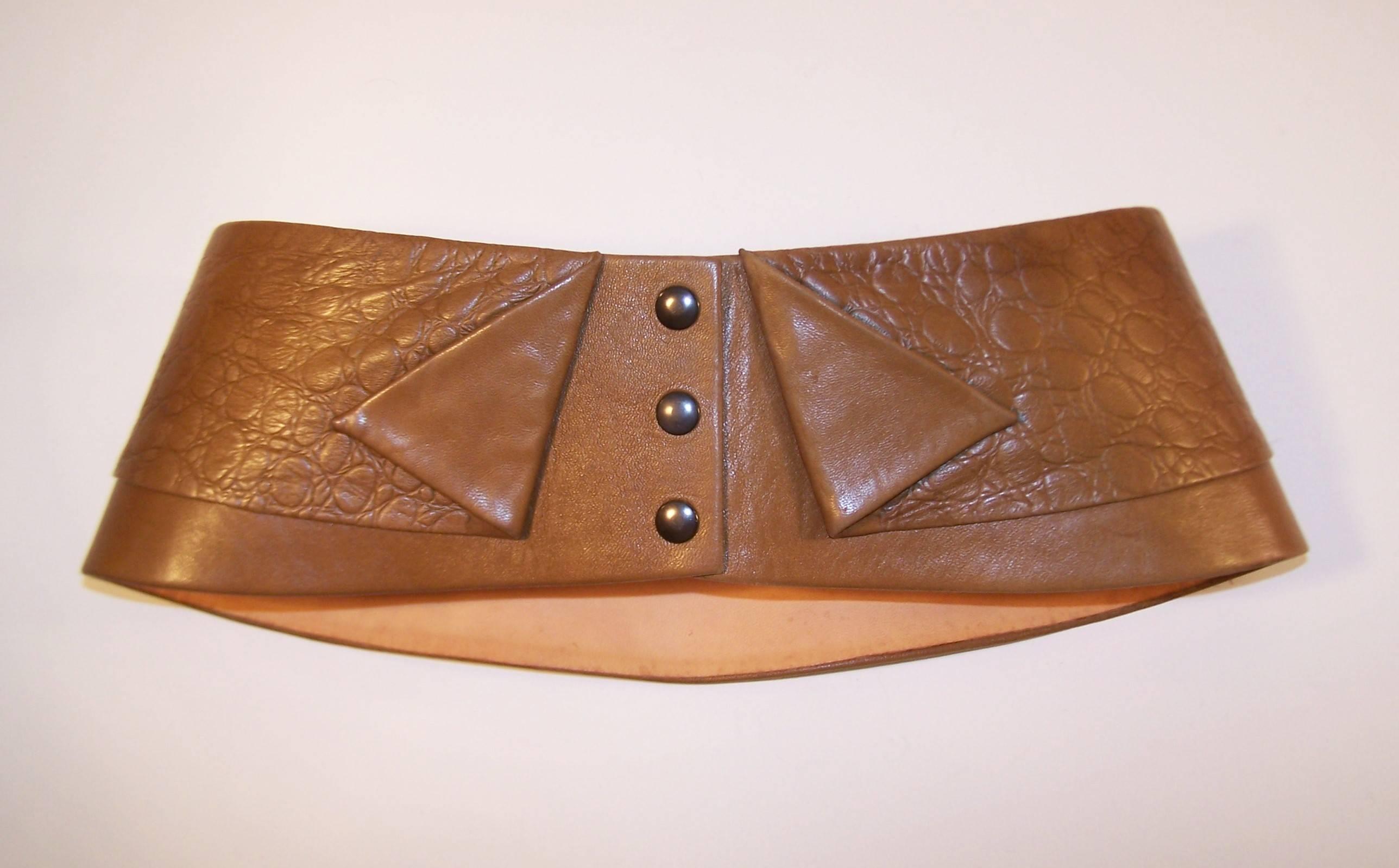 Belts are the perfect accessory to complete a fashionable 'look' and this 1980's corset belt from Lasso of France promises to be the icing on the cake.  It is designed with a supple camel color leather that has a hint of olive undertones.  It snaps