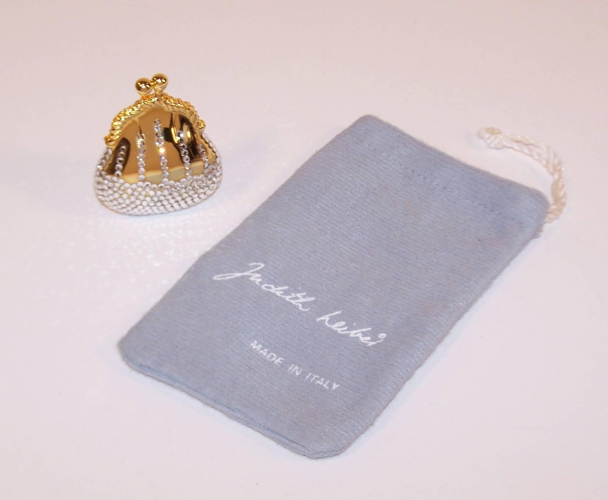 This precious bauble is masquerading as a fashion accessory.  Fully functional as a pillbox, the crystal encrusted money bag shaped pouch by Judith Leiber has a kiss lock closure and measures 2" x 1.63" x .75".  As with all Ms.