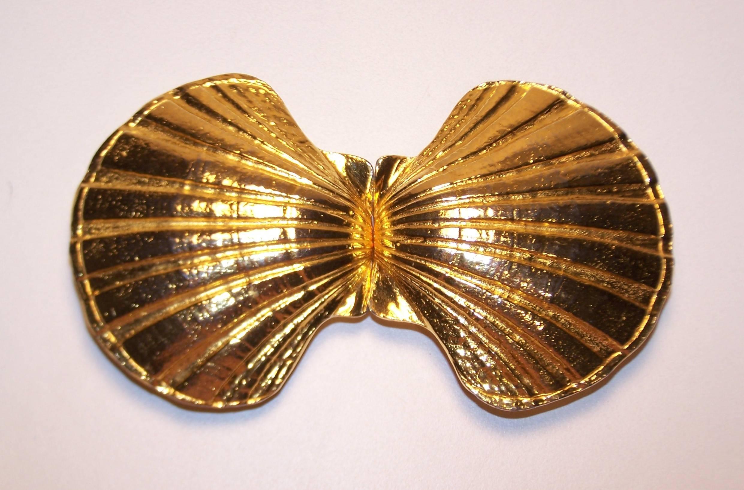Mimi di Niscemi started her career as a jewelry designer both working for the manufacturer that produced Schiaparelli designs as well as Arnold Scaasi.  Her famous belt buckles were designed to mix and match with various color strips allowing for