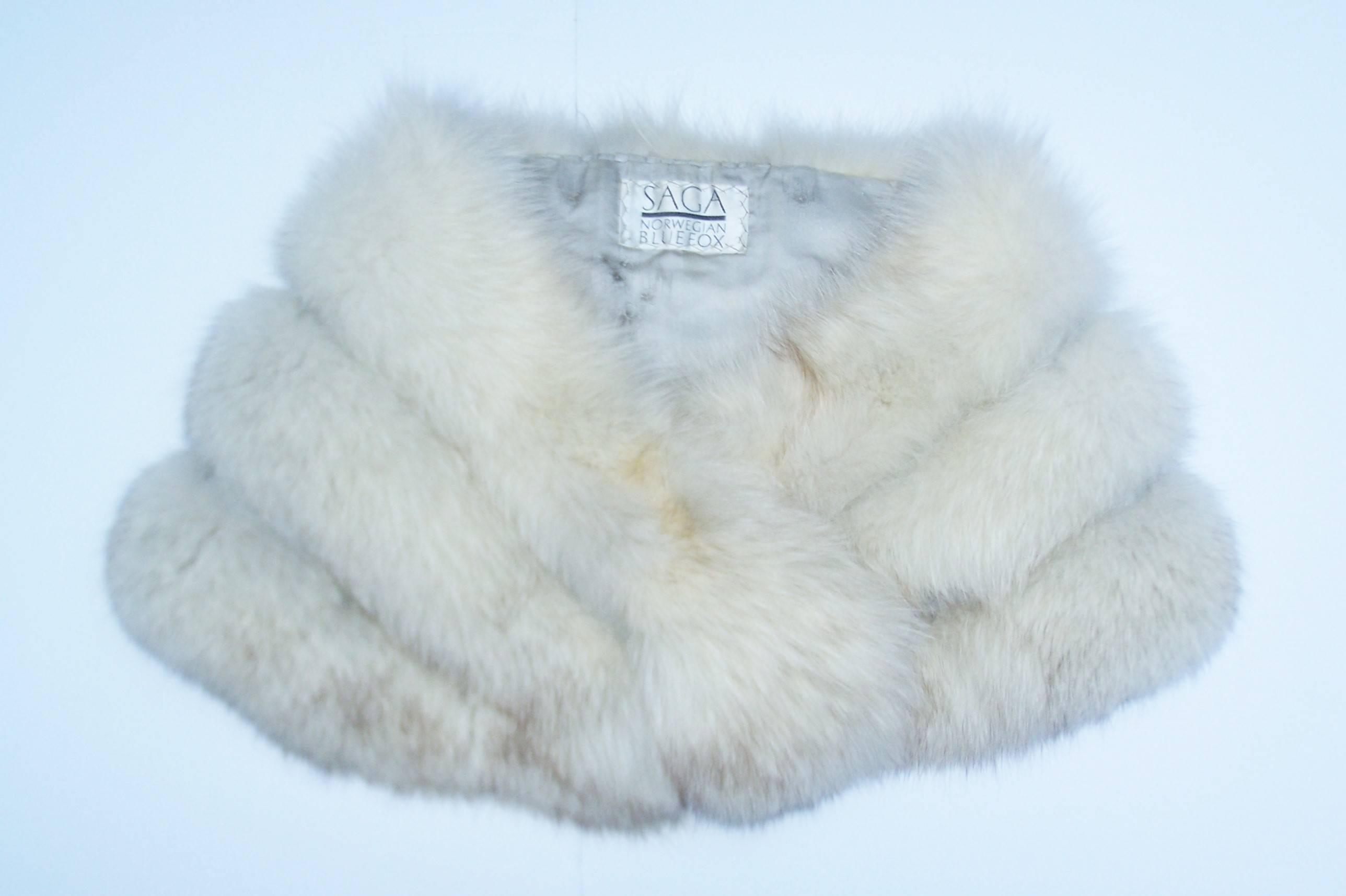 They will see you coming but they will really notice you going when wearing this gorgeously glamorous Norwegian blue fox fur stole by Saga Furs.  This 1970's design functions beautifully as a classic stole but it has an updated look with a