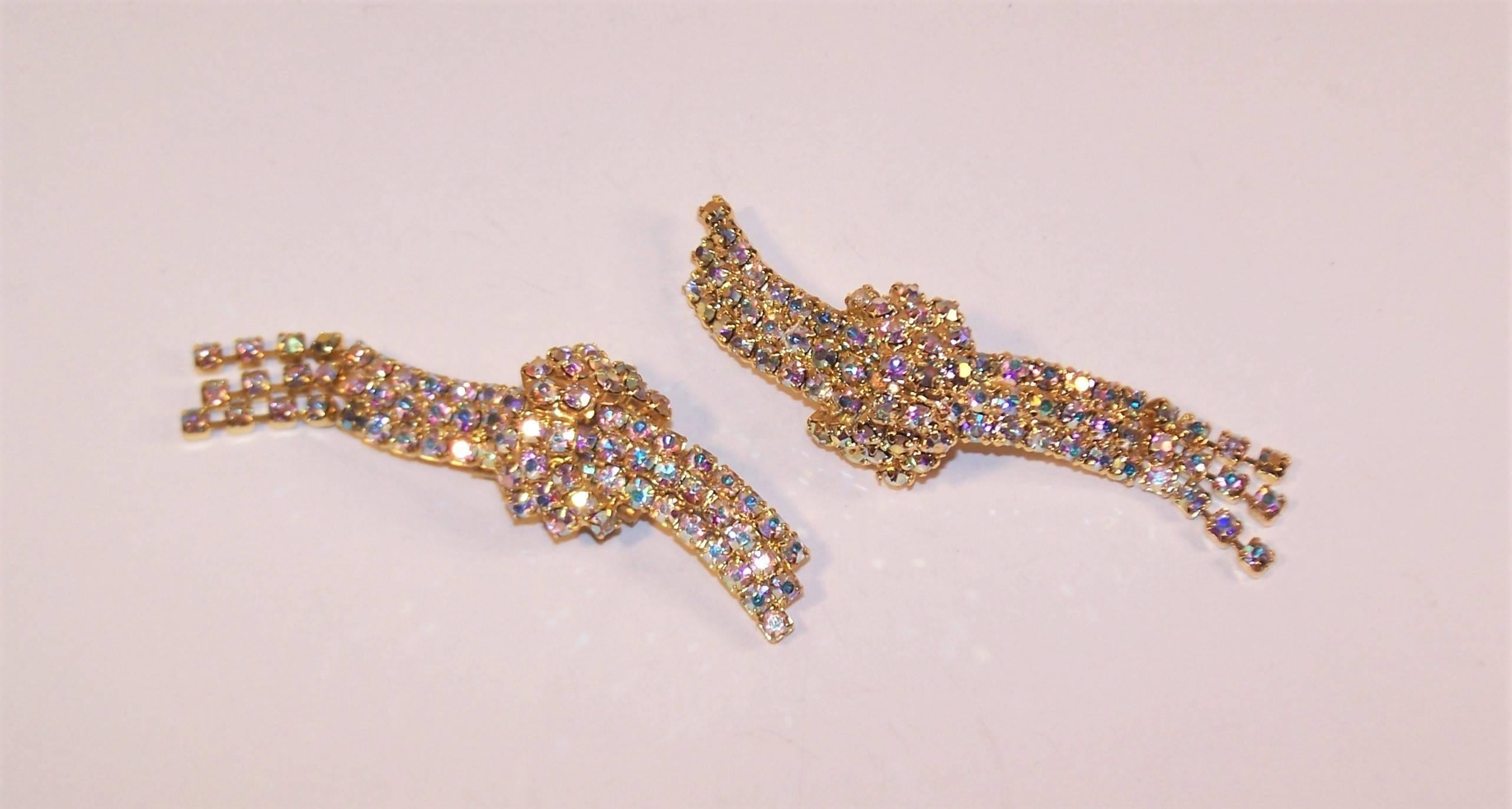 Old school shoe clips are a great idea to transform the look of a classic pump or add a little pizzaz to an evening look.  These clips have the added bonus of a serpentine shape with articulated dangles and aurora borealis rhinestones that look good