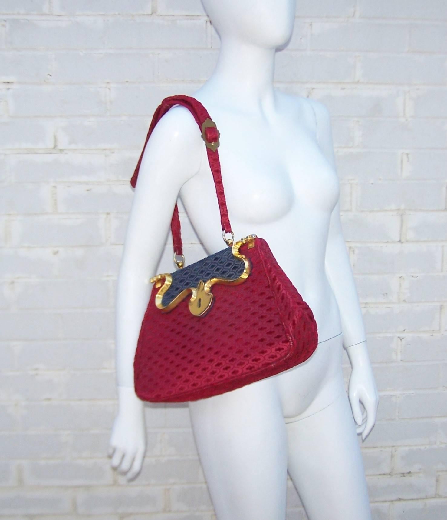 We are big fans of Roberta Di Camerino's handbags ... each one is like a precious tactile treasure.  This 1950's design for Saks Fifth Avenue has a carpetbag sensibility in a wonderful ruby red and navy blue cut velvet.  As if the rich color