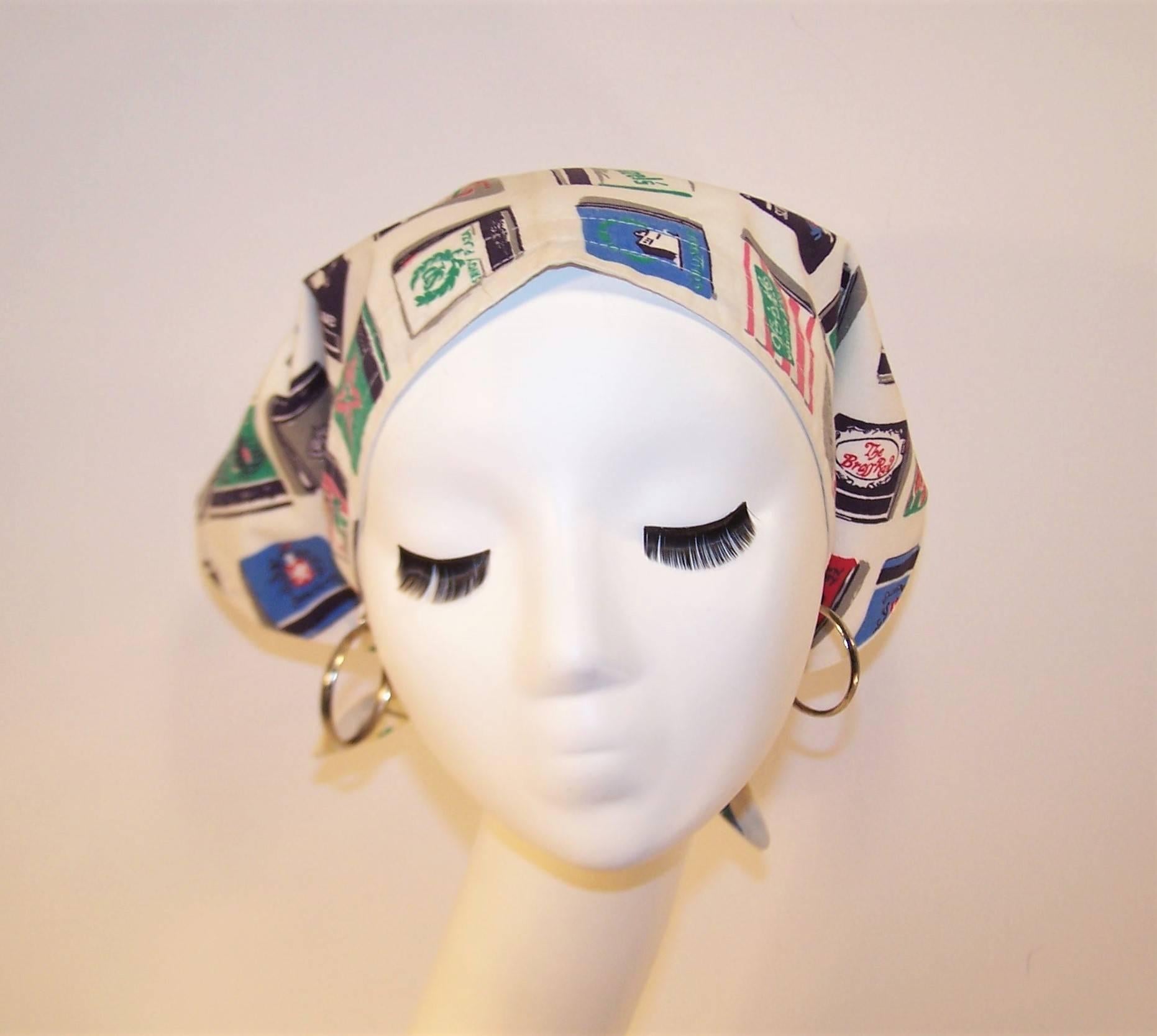 Oh what fun!  You'll have a true conversation piece with this triangular head scarf designed with a cotton fabric featuring trompe l'oeil matchbooks of all shapes and sizes.  And just wait until they realize your silver hoop earrings are actually