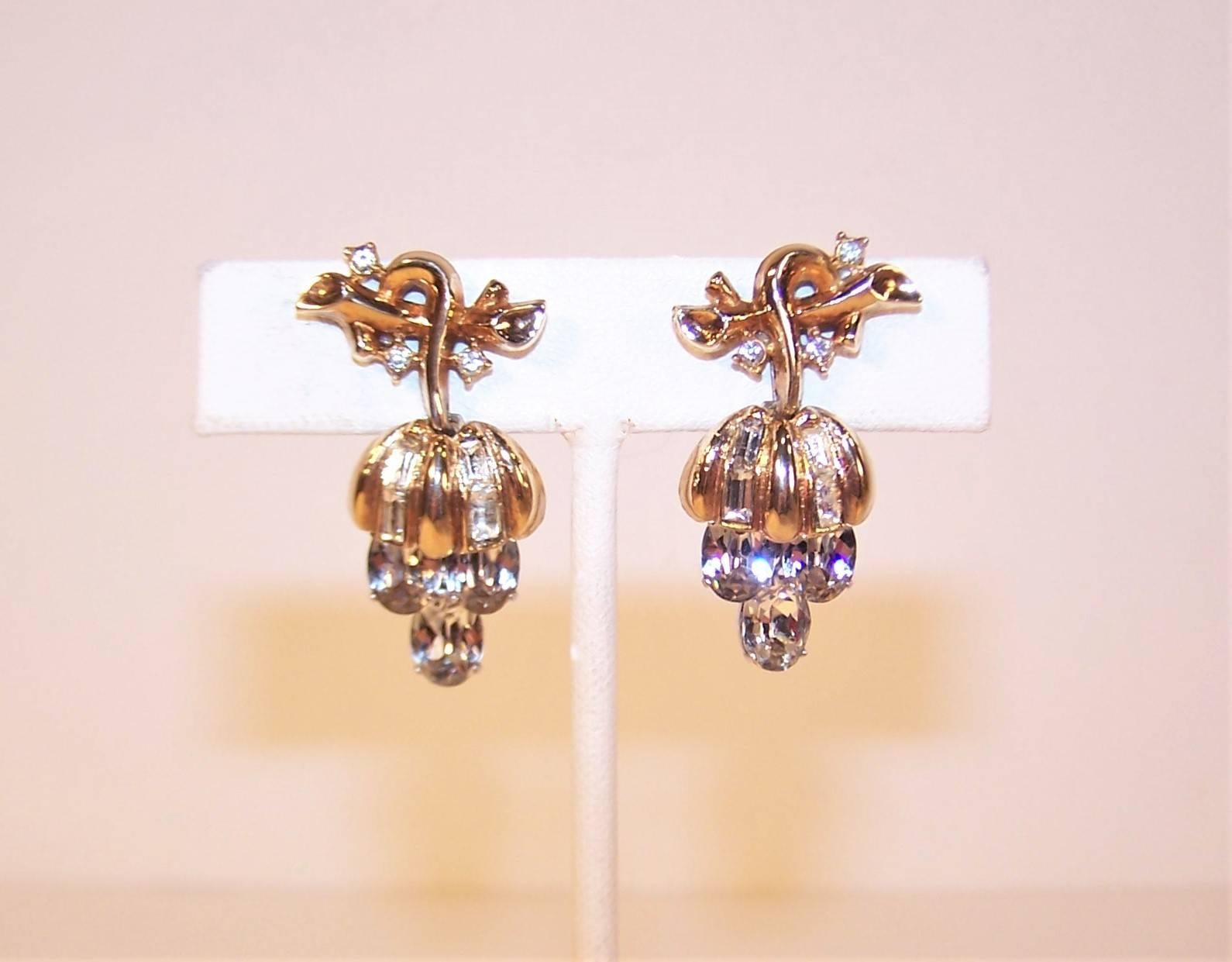 Pretty and petite with a small scale but a big look!  These precious Crown Trifari C.1950 earrings resemble a cluster of grapes with the clip on base serving as a vine and an articulated dangle base replicating hanging fruit.  The gold tone body has