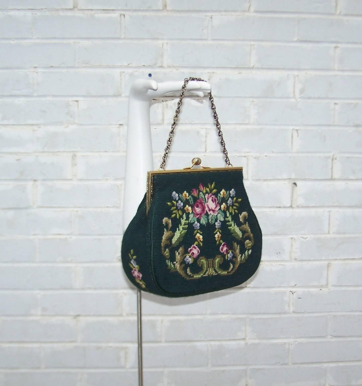 Not all 'granny bags' are created equal!  This 1950's needlepoint example is at the front of the pack with a versatile green background touched with a hint of teal and a double sided floral inspired decoration including petit point roses and swirls