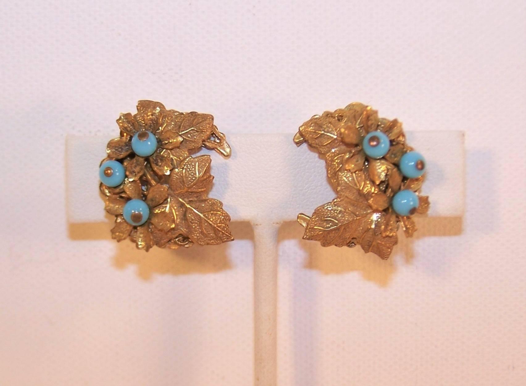 These lovely C.1980 clip-on earrings by Stanley Hagler are an excellent example of his intricate handwork in a pretty & petite package.  Each earring is fabricated from a crescent shaped filigree base similar in style to Miriam Haskell jewelry