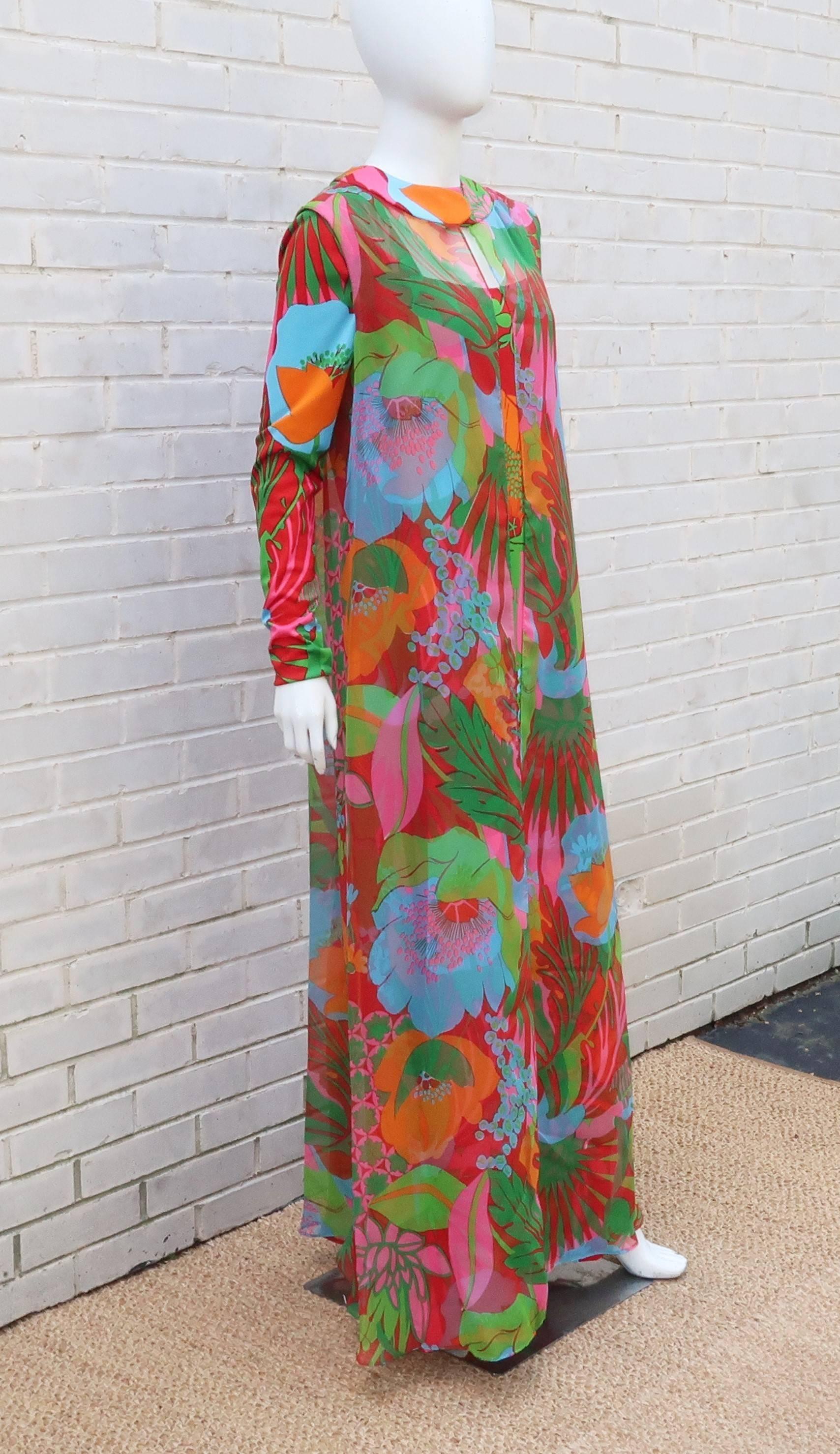 Don Luis de España was known for colorful prints and this mod 1960's two piece maxi dress is here to prove it!  The long tall silhouette is designed with a polyester jersey in red, orange, aqua and pink in a tropical style floral print.  The long
