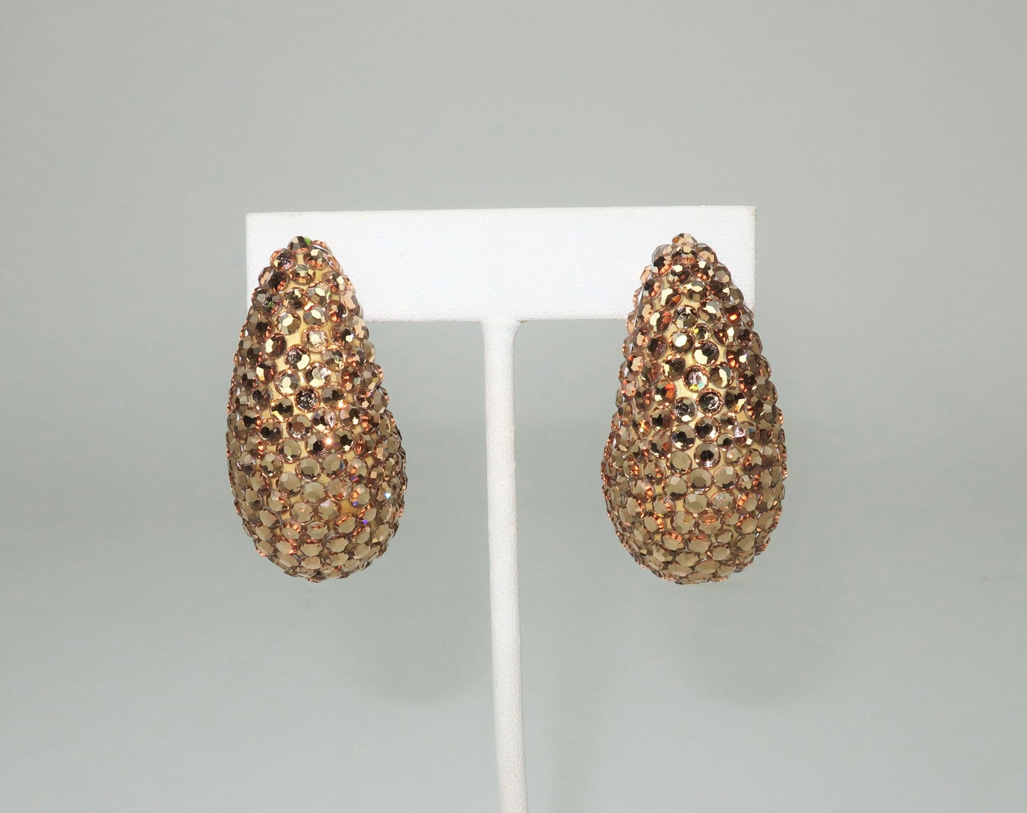 Glorious golden perfection!  These 1980's Richard Kerr earrings are mesmerizing.  The nautilus shaped clip ons are fully encrusted in pave crystals that catch the light at every turn.  Each earring measures 1.88" long x .88" wide x