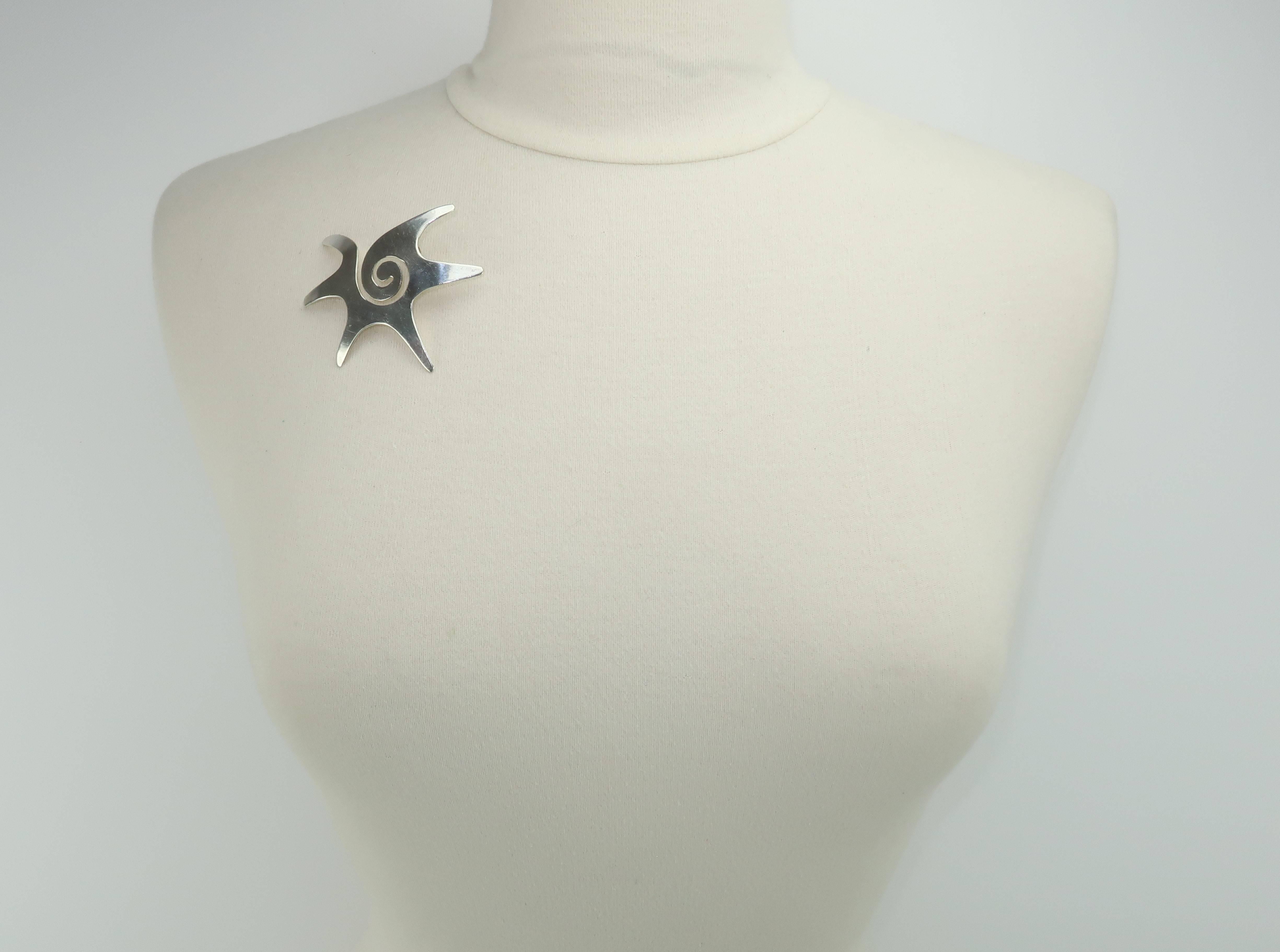 Superior Mexican sterling silver craftsmanship is united with a 1960's abstract modernist form to create a sterling silver Taxco hallmarked brooch with eye popping style.  The abstract silhouette is reminiscent of William Spratling's starfish design