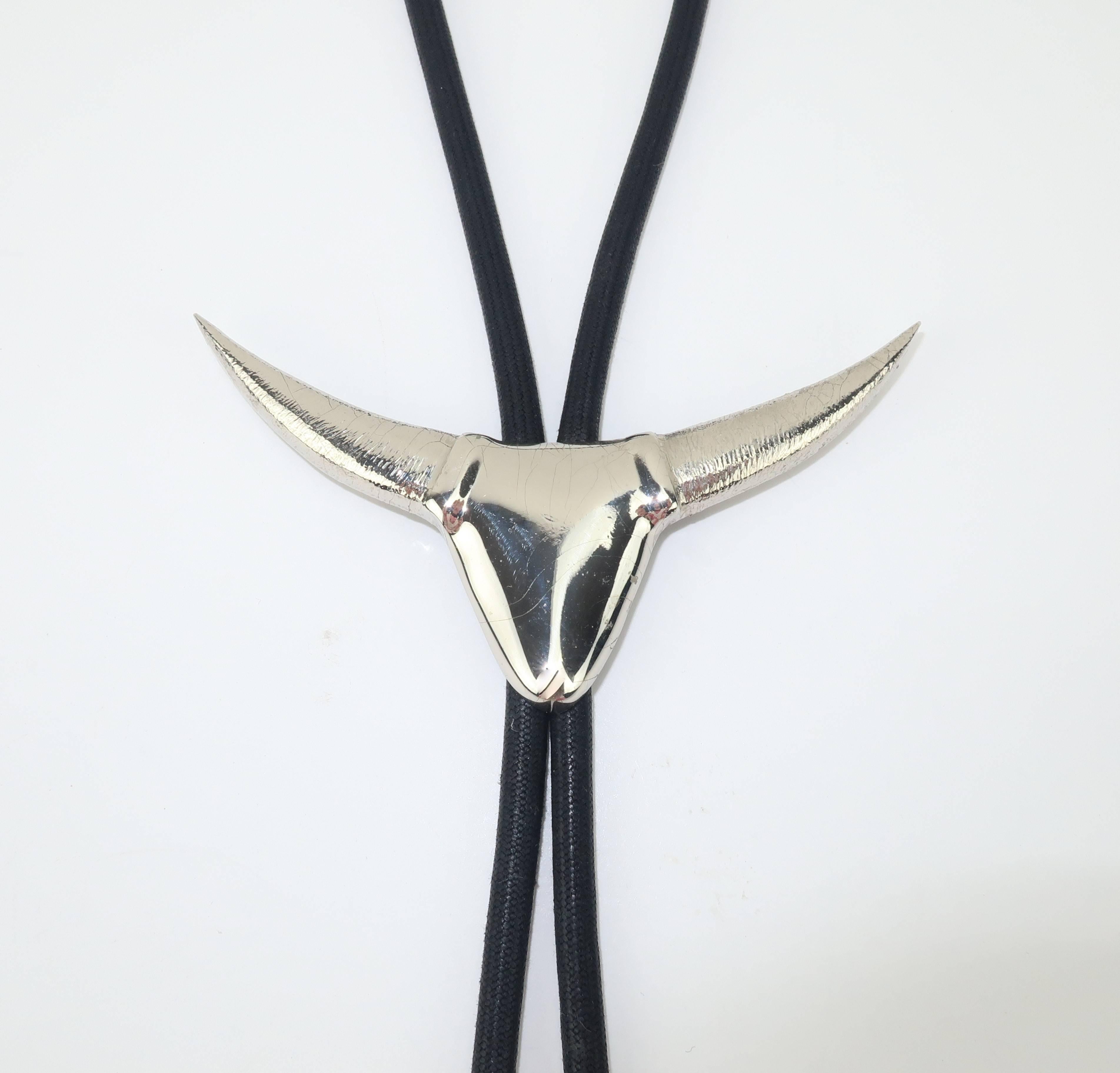 French designer Thierry Mugler is a master of the innovative suit incorporating strong shoulders and wasp waist silhouettes to create a feminine elegance with a healthy dose of sex appeal.  This combination of a chromed base metal longhorn brooch