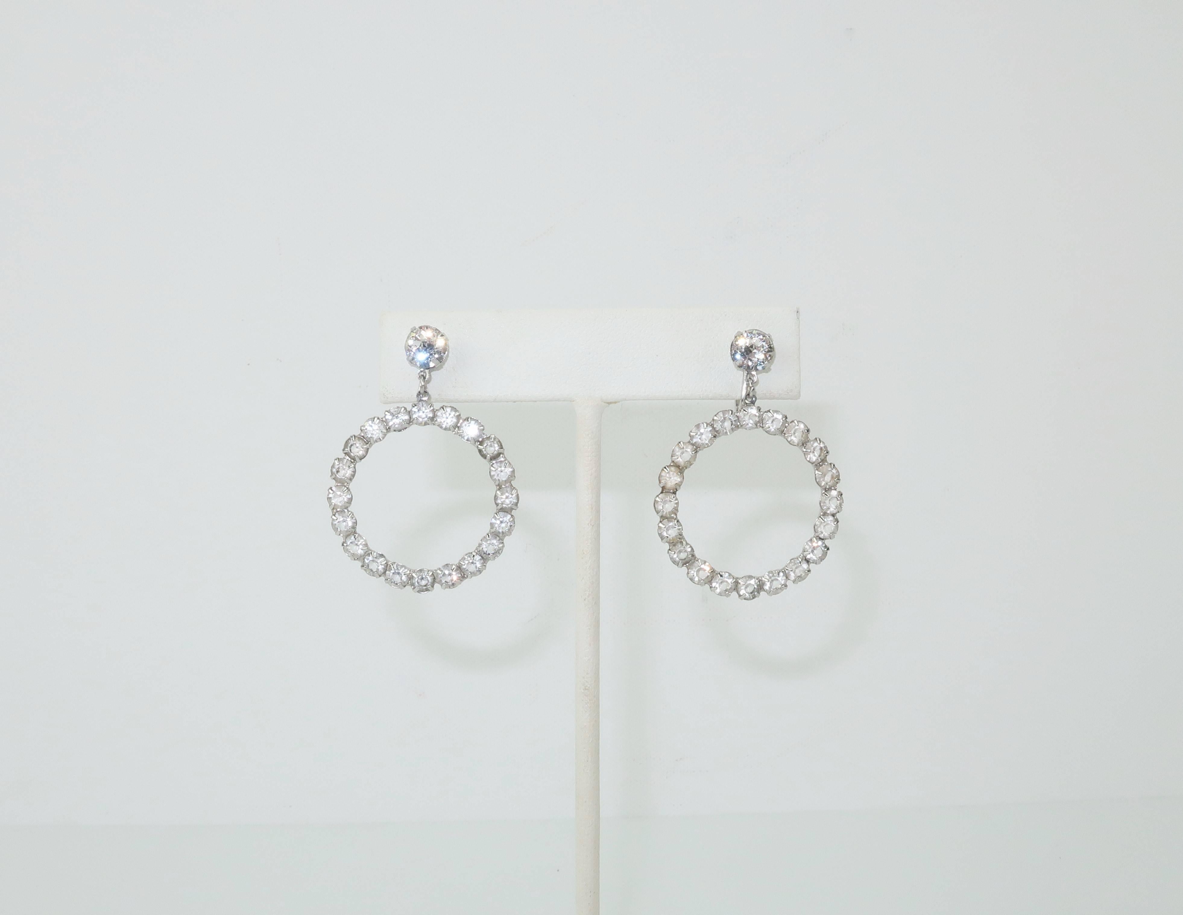 Add vintage glamour to your look with these 1950's sterling silver hoop earrings fully embellished with sparkling crystal rhinestones.  The articulated dangle design provides movement giving the sparklers a chance to catch the light.  The screw back