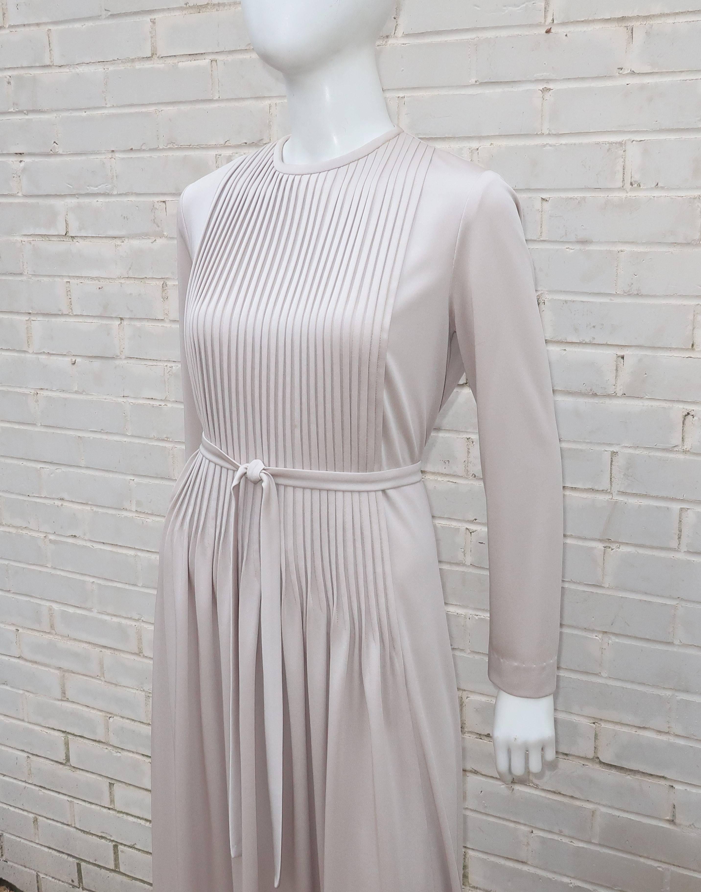 This 1970's Stephan Casual dress for Saks Fifth Avenue is loaded with stylish details which are designed to highlight the lady wearing the dress and not vice versa.  The simple design is fabricated from a high quality platinum gray polyester jersey