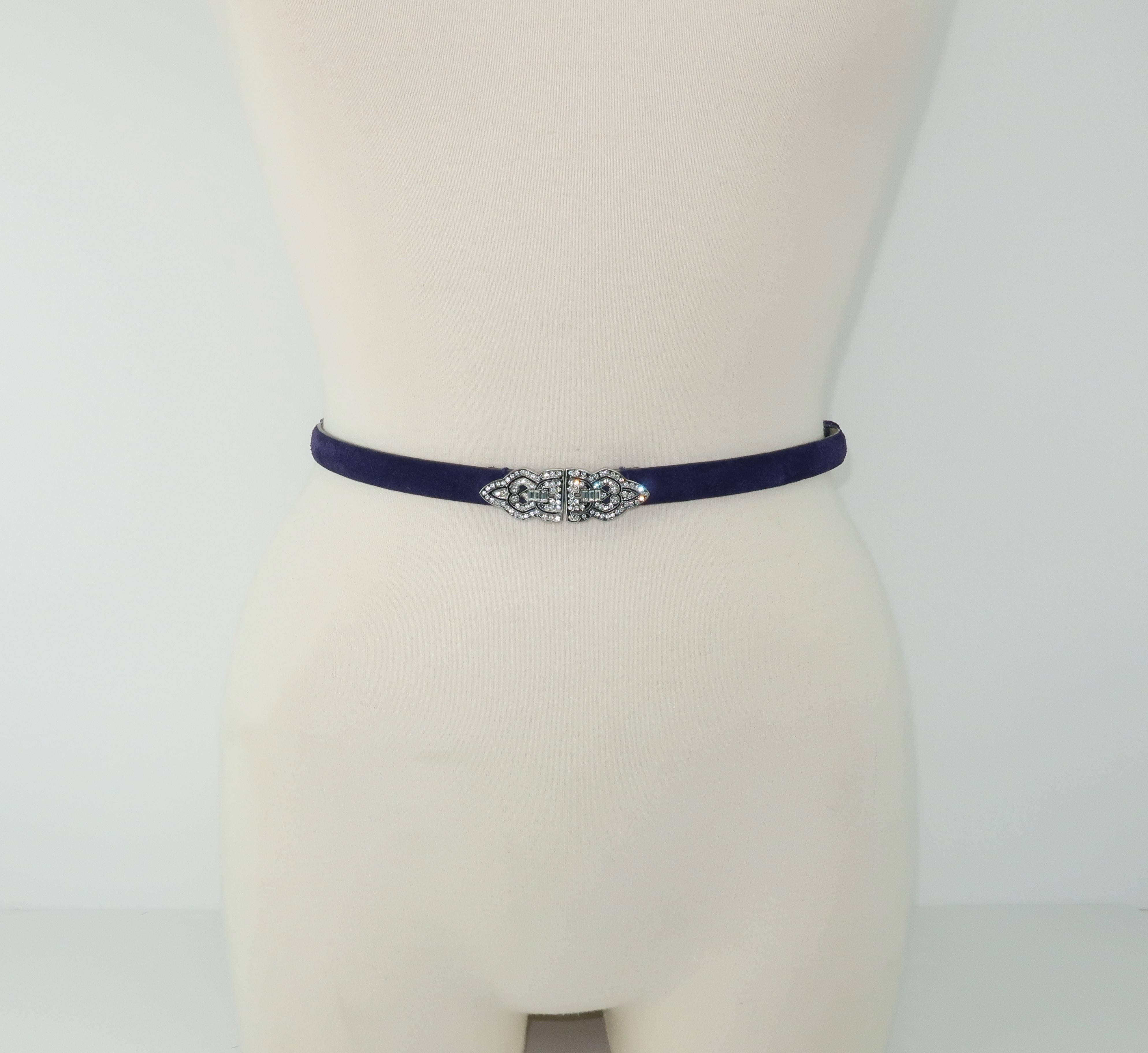 Ralph Lauren puts a contemporary spin on a classic art deco design with this rhinestone encrusted buckle and royal purple suede belt.  The 'skinny' design is perfect for adding an accent to a dress or cinching the waist of wide leg trousers for an