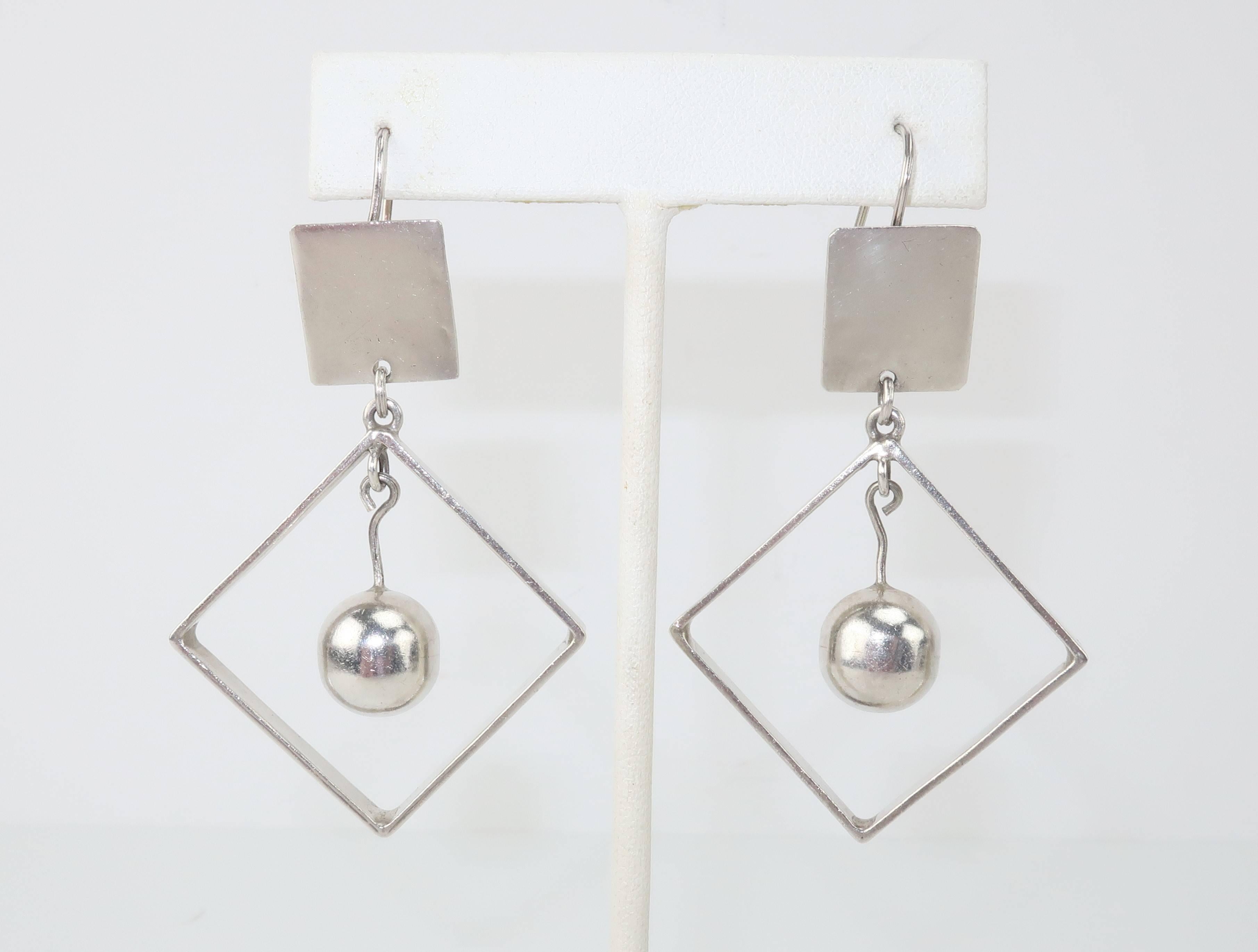 These Taxco, Mexico artisan sterling silver earrings offer a geometric mobile for the ears.  The square base serves to support an open square dangle which suspends a 'dancing' orb.  All parts move of their own accord providing a fun and fanciful