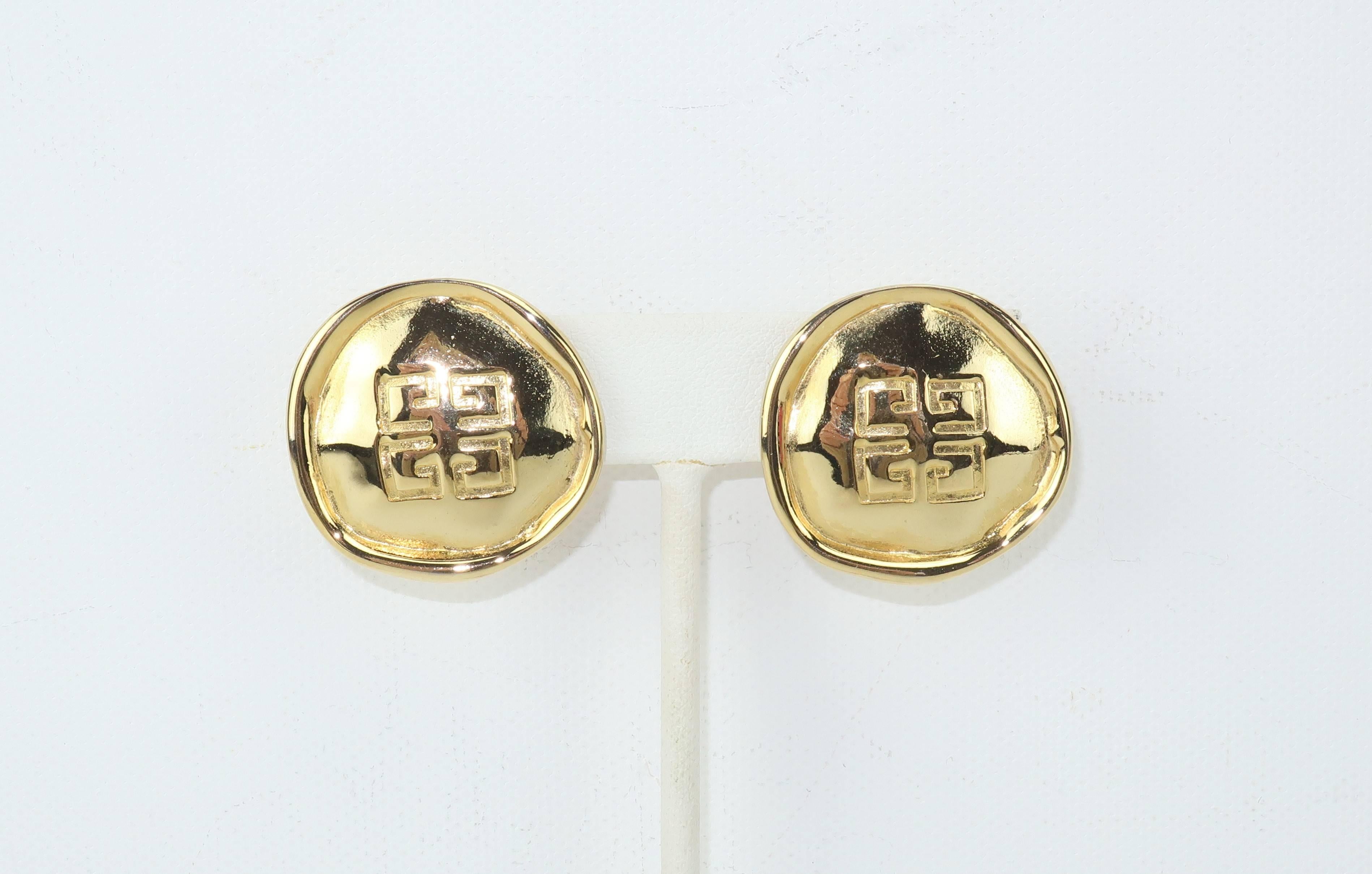 Much like his lovely clothing designs, Hubert de Givenchy created elegant and feminine costume jewelry starting in the 1950's and throughout his career.  These 1980's gold tone metal earrings have a hand hammered look in a button shape.  Each
