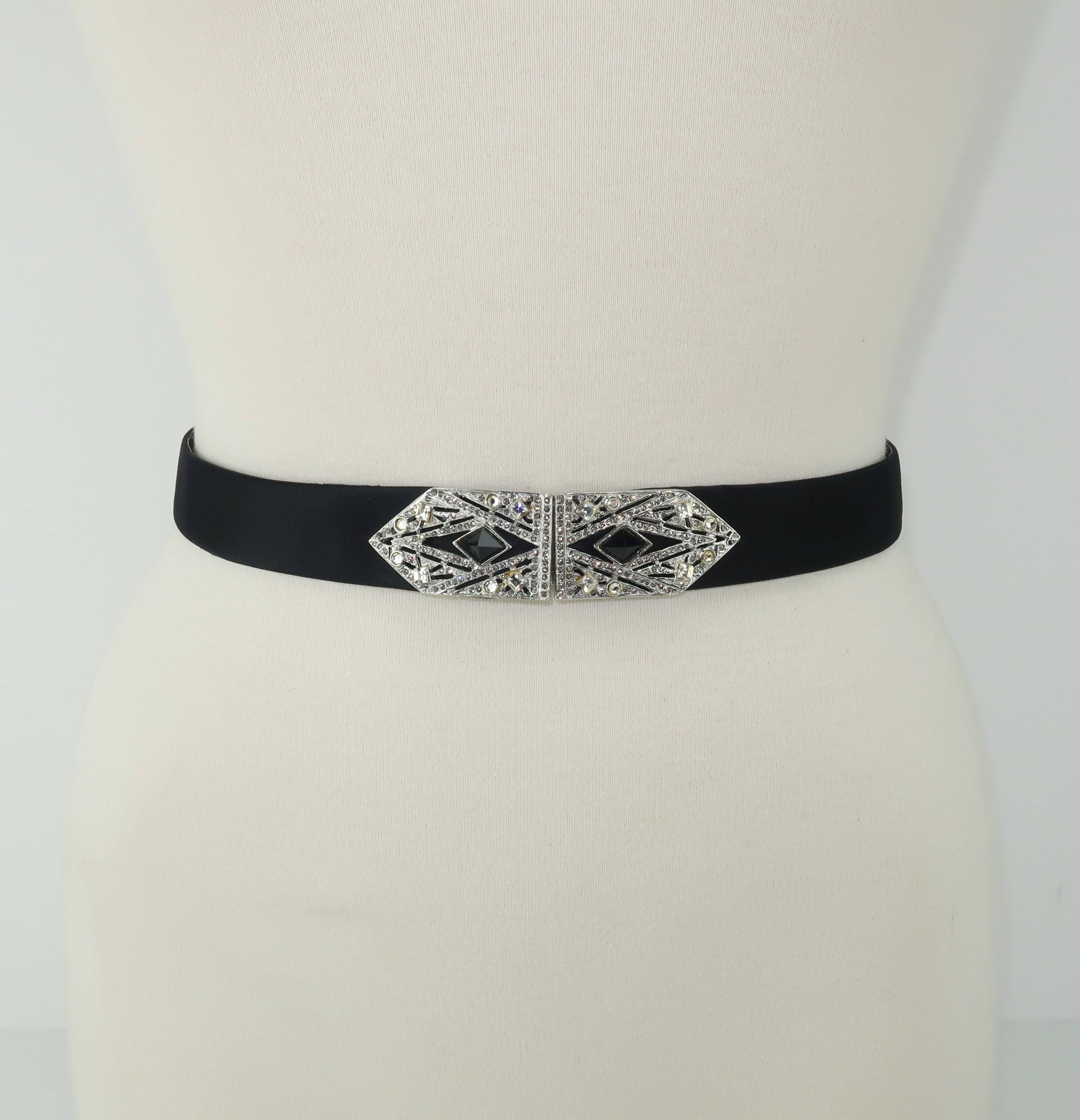Judith Leiber puts a contemporary spin on a classic art deco design with this rhinestone and black crystal encrusted buckle with black satin belt. The buckle hooks at the front and the belt easily adjusts size with an overlapped slide design.