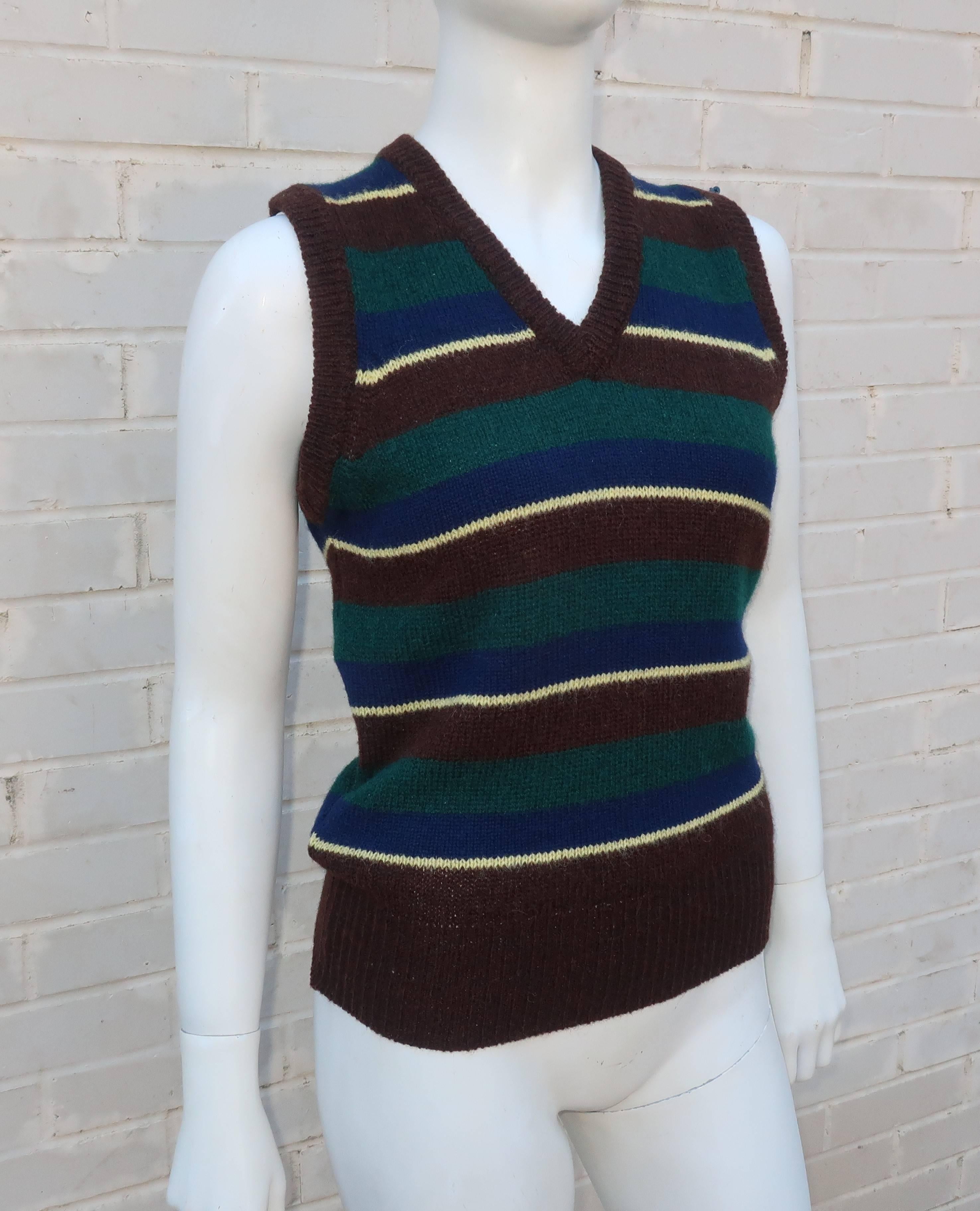 Add a preppy finishing touch to your ensemble with this 1970's Ralph Lauren sweater vest. Vests are a great way to add a menswear influence to your look and offer the practical benefit of a little warmth. The classic striped pattern is a navy blue,