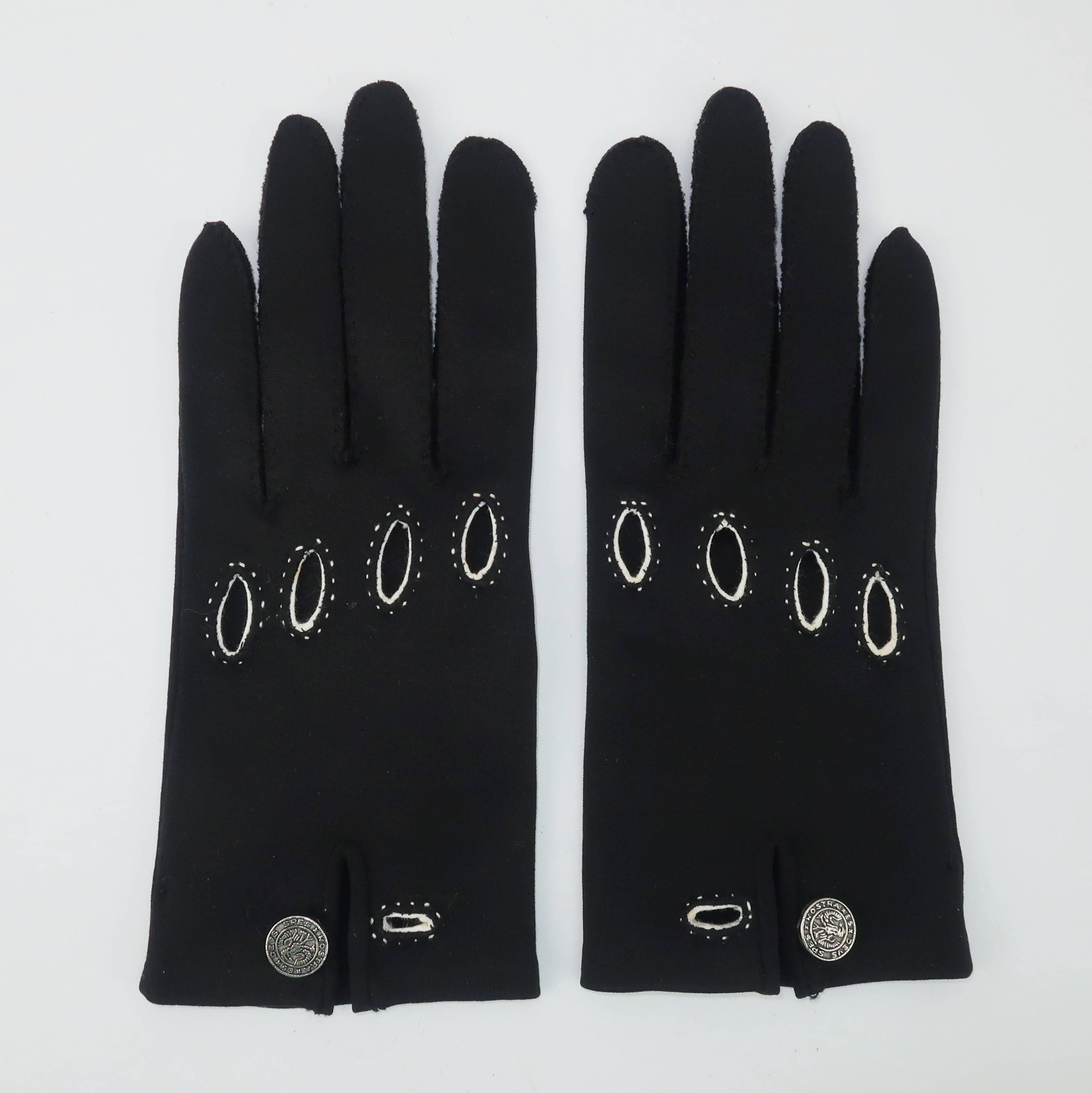 These Saks Fifth Avenue gloves are a fashionable fix to the classic driving glove.  The black polished cotton body is accented with bright white stitching at the cut outs and wrist.  A silver metal button decorates the wrist with the slogan 'Spes