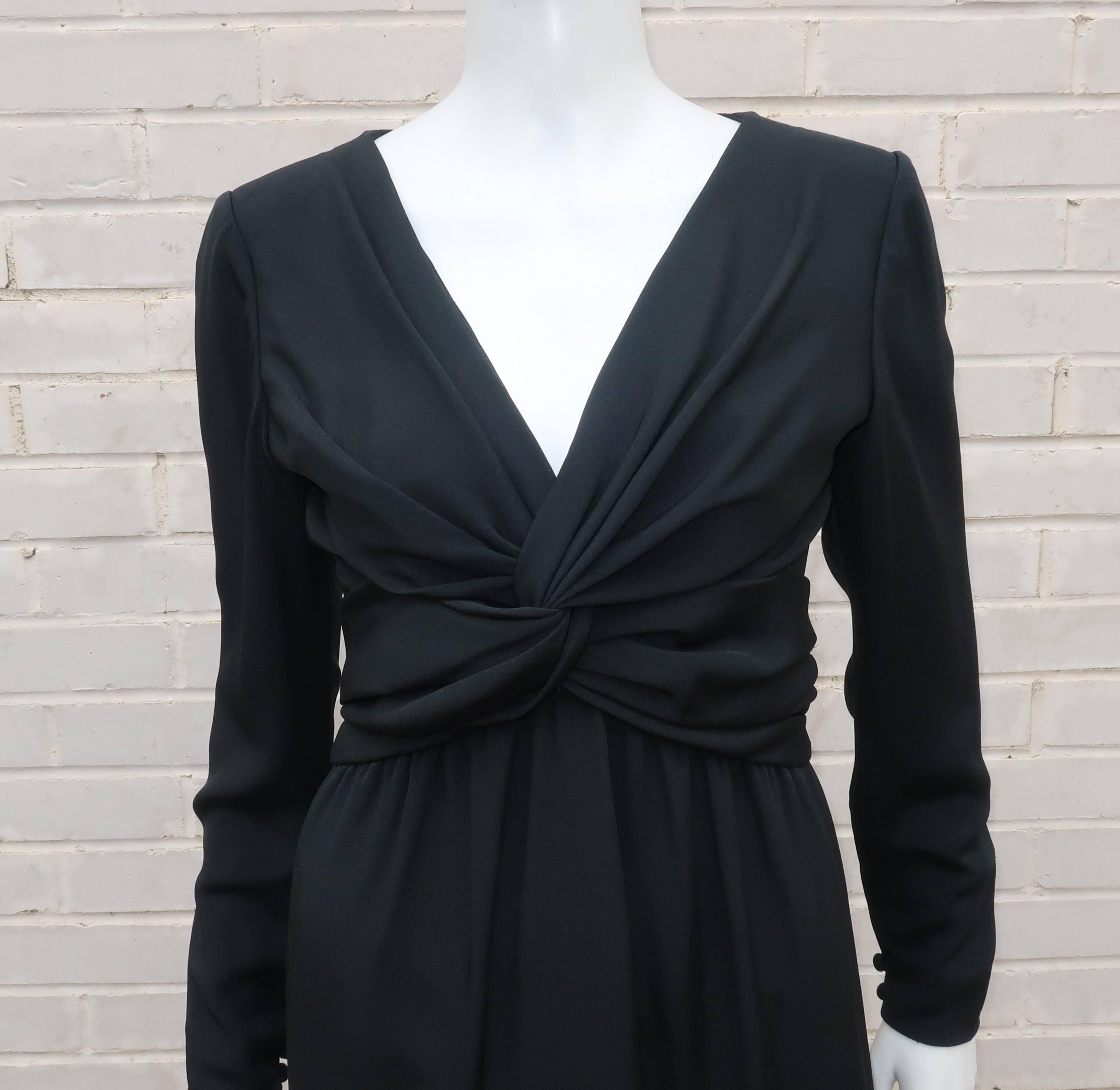 Bill Blass puts a sophisticated twist on the ‘little black dress’.  This sleek design is fabricated from a fine silk faille with a ruched detail at the bodice that criss crosses to create a fashionable twisted knot at the bust.  It zips and hooks at