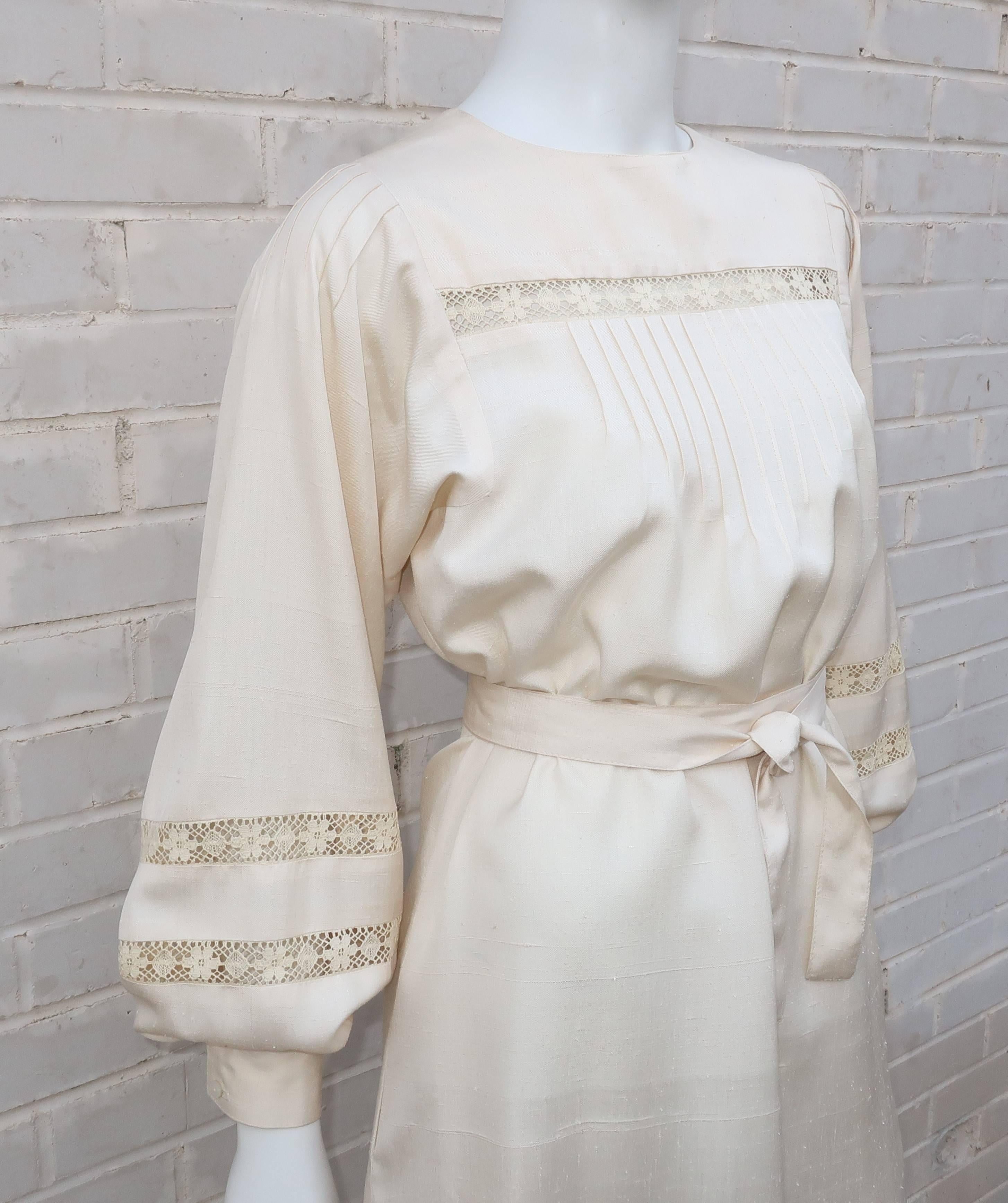 This ladylike ivory dupioni silk dress by Albert & Pearl Nipon is loaded with lovely details typical of the Albert Nipon label.  The smock style collarless dress zips at the back and features side pockets, pintucking and lace inserts at the