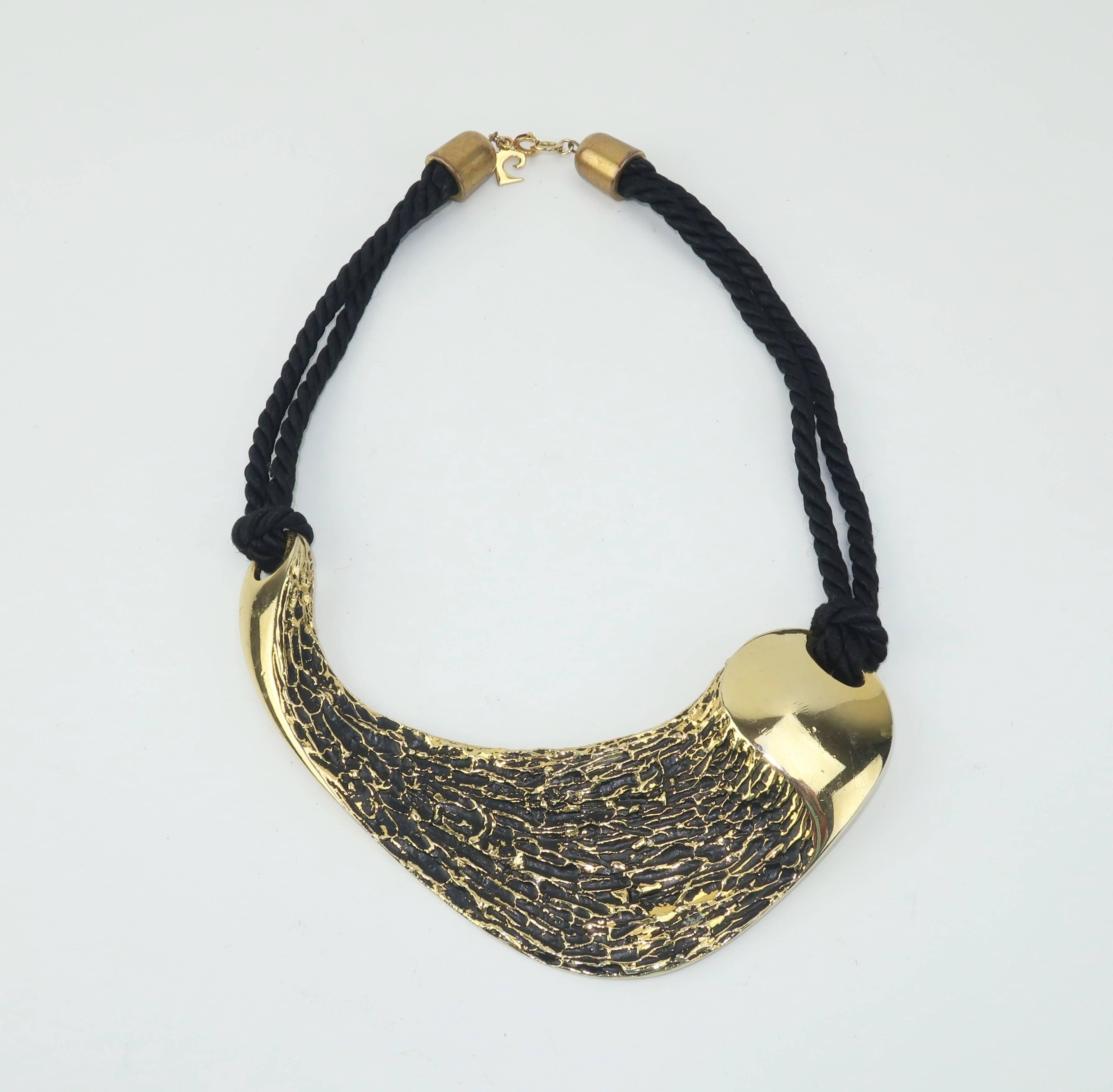 Pierre Cardin's designs from the 1960's and 1970’s are the epitome of the mod and futuristic vision of the time. This sculptural gold tone necklace has a brutalist aesthestic that is the perfect contrasting compliment to the feminine form.  The