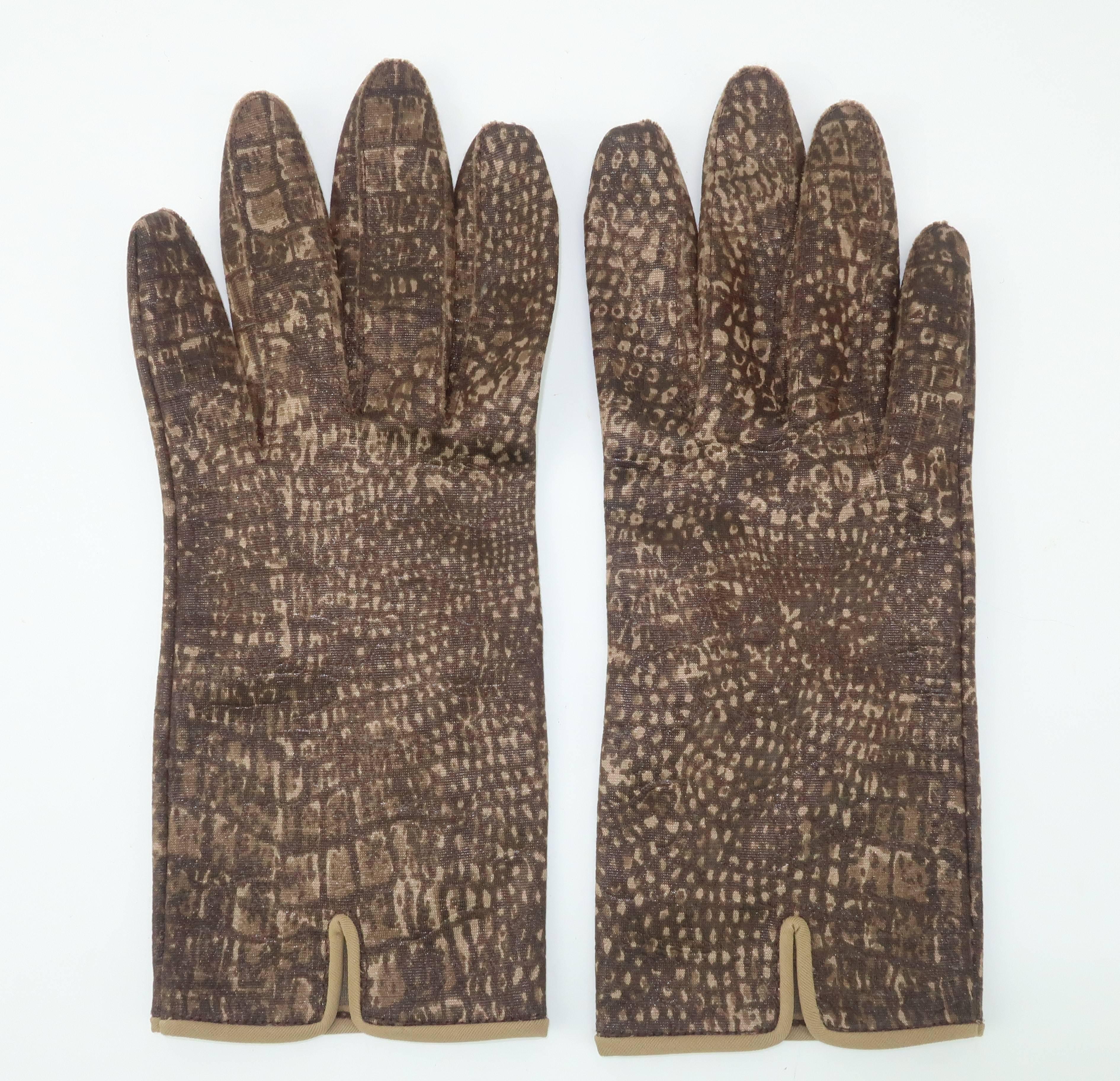Fabulous faux!  These fun 1960's fashion gloves, by Hansen, are designed with a nylon fabric featuring a printed and embossed texture that replicates alligator skin.  The brown and beige colors also bear a touch of olive green with a vented detail