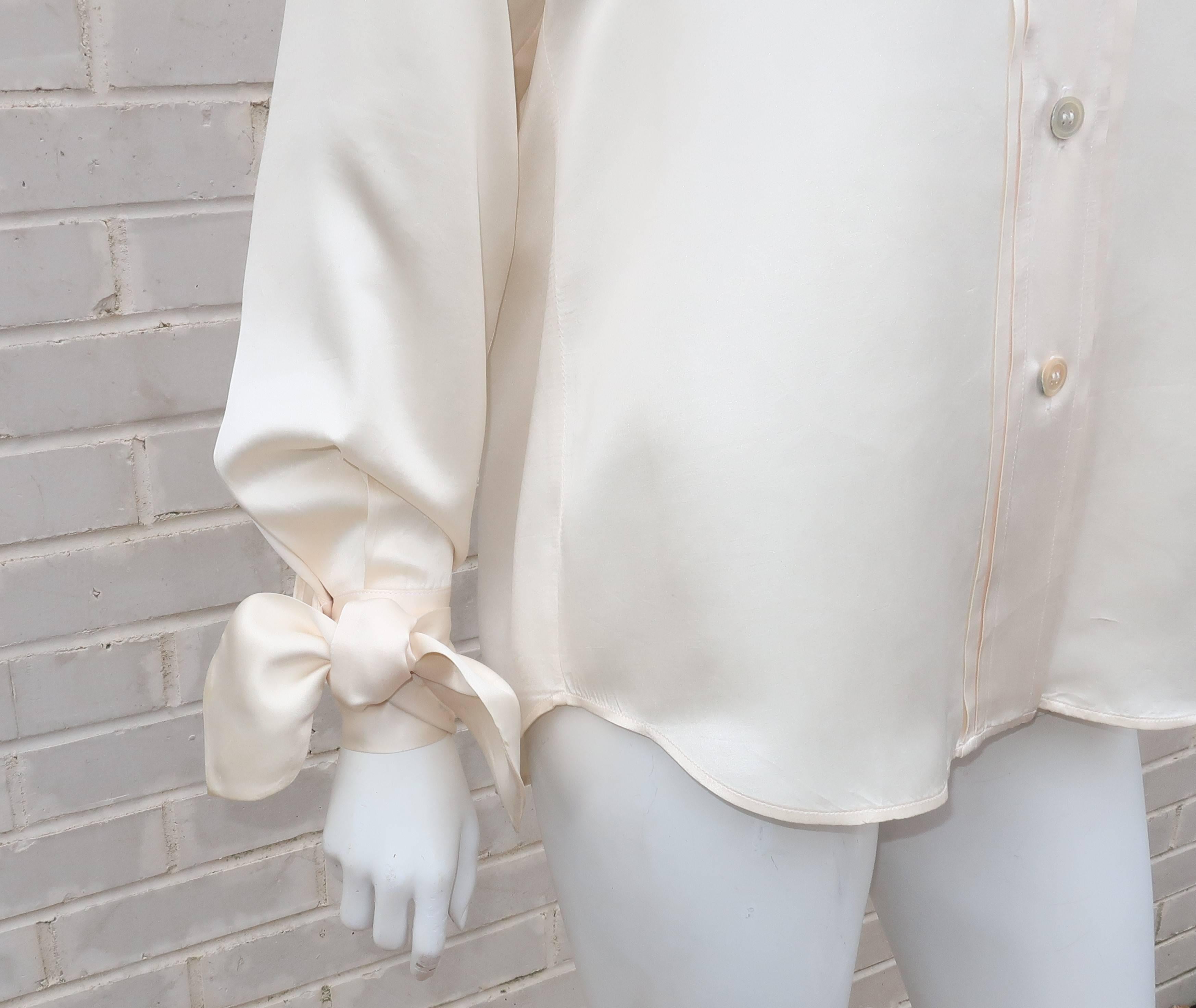 There is something otherworldly about Romeo Gigli designs ... romanticism wrapped up in a modern construction with a nod to the past.  This blouse evokes that Gigli spirit by mixing a beautiful ivory silk satin fabric with a crossover collar and