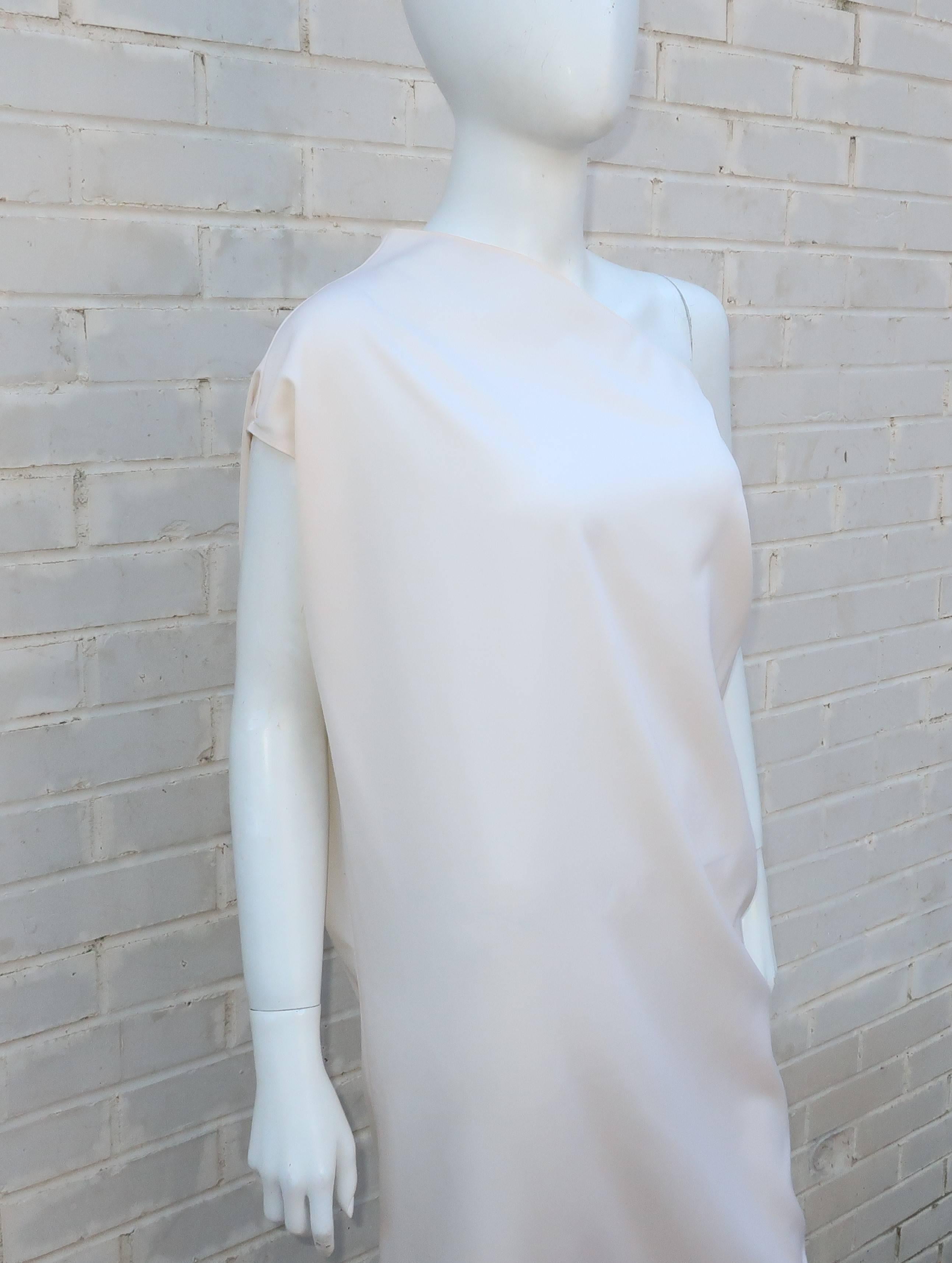 Combine contemporary Italian design and a classic goddess silhouette for this simple yet stunning Krizia winter white wool dress.  Somewhat akin to a shift, the dress is a pullover construction without much structure except the feminine shape