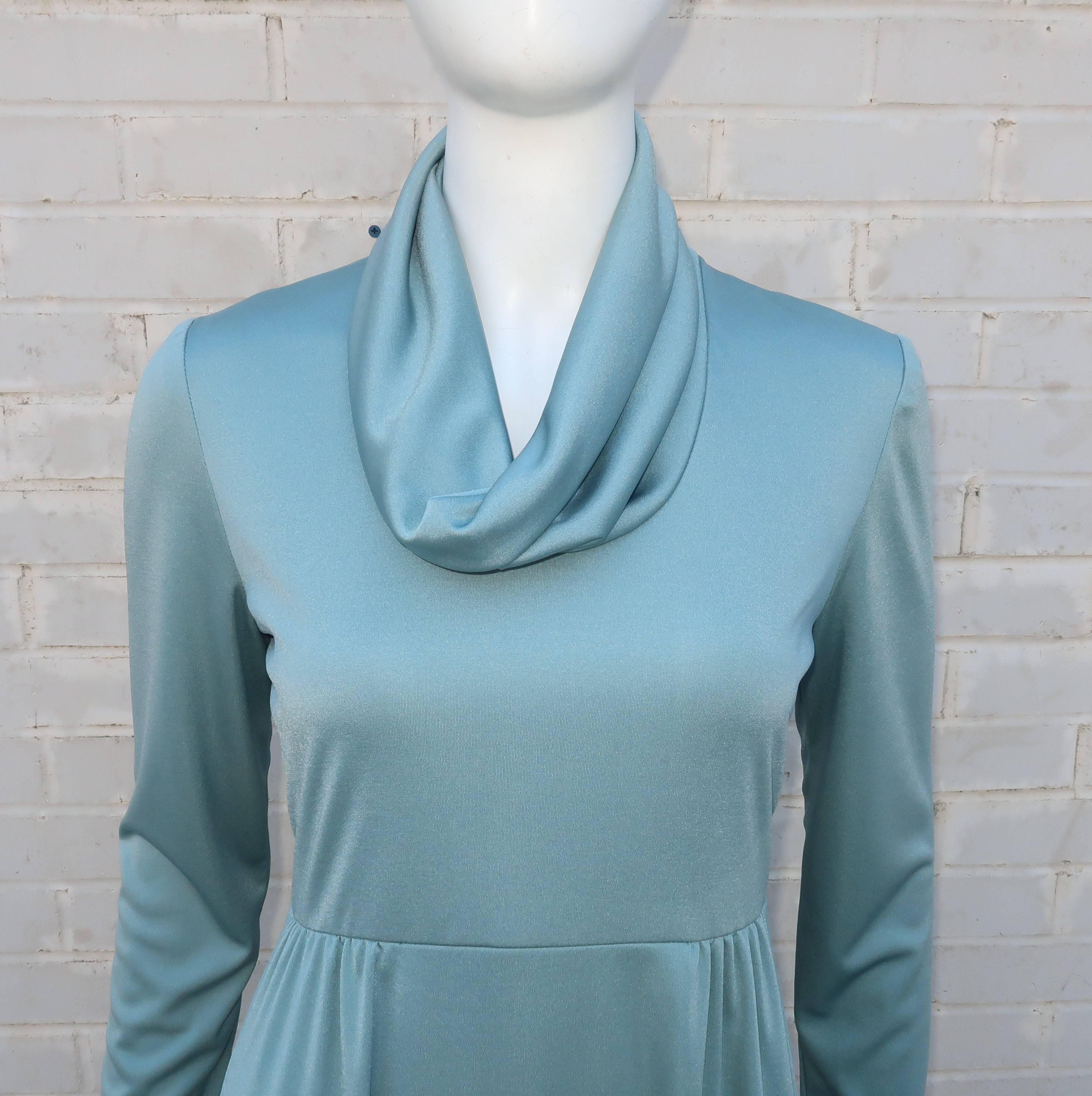 The luxurious feel of silk jersey with the easy care of polyester ... this 1970’s Act I New York seafoam dress has it all.  The body conscious drape of the silhouette is perfect to create a fluid disco look especially when paired with a strappy
