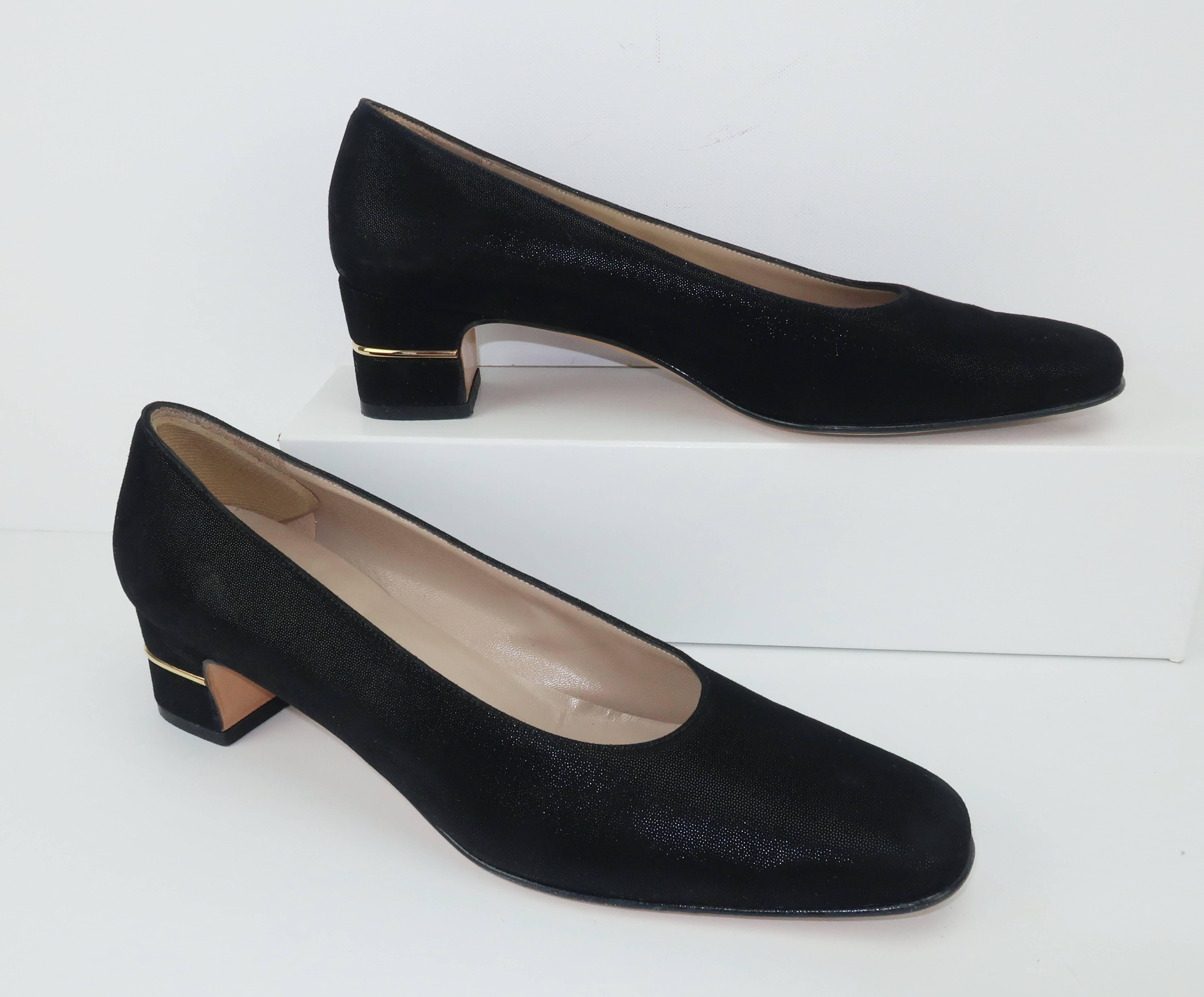 Classic Ferragamo sensibility with stylish details makes these black suede shoes a functional option for everything from day wear to evening attire.  The body of the shoe is formed with a laminated suede which gives the subtle effect of a shimmer or
