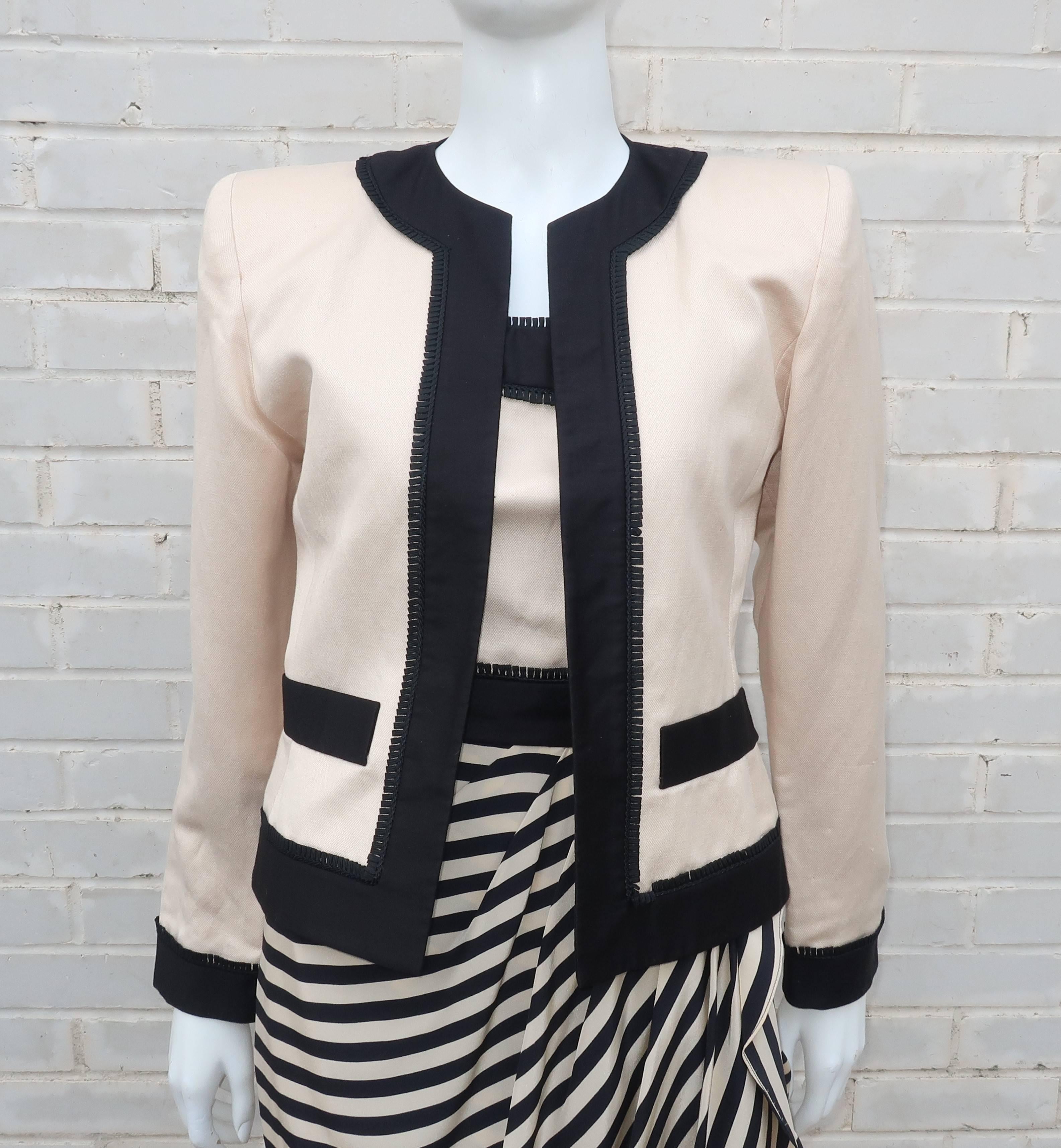 Elegance with a stylish combination of black and ivory graphics are the hallmarks of this 1980's Liancarlo dress and jacket ensemble.  The strapless dress has a polished cotton and linen bodice with a striped silk sarong style skirt.  It zips and