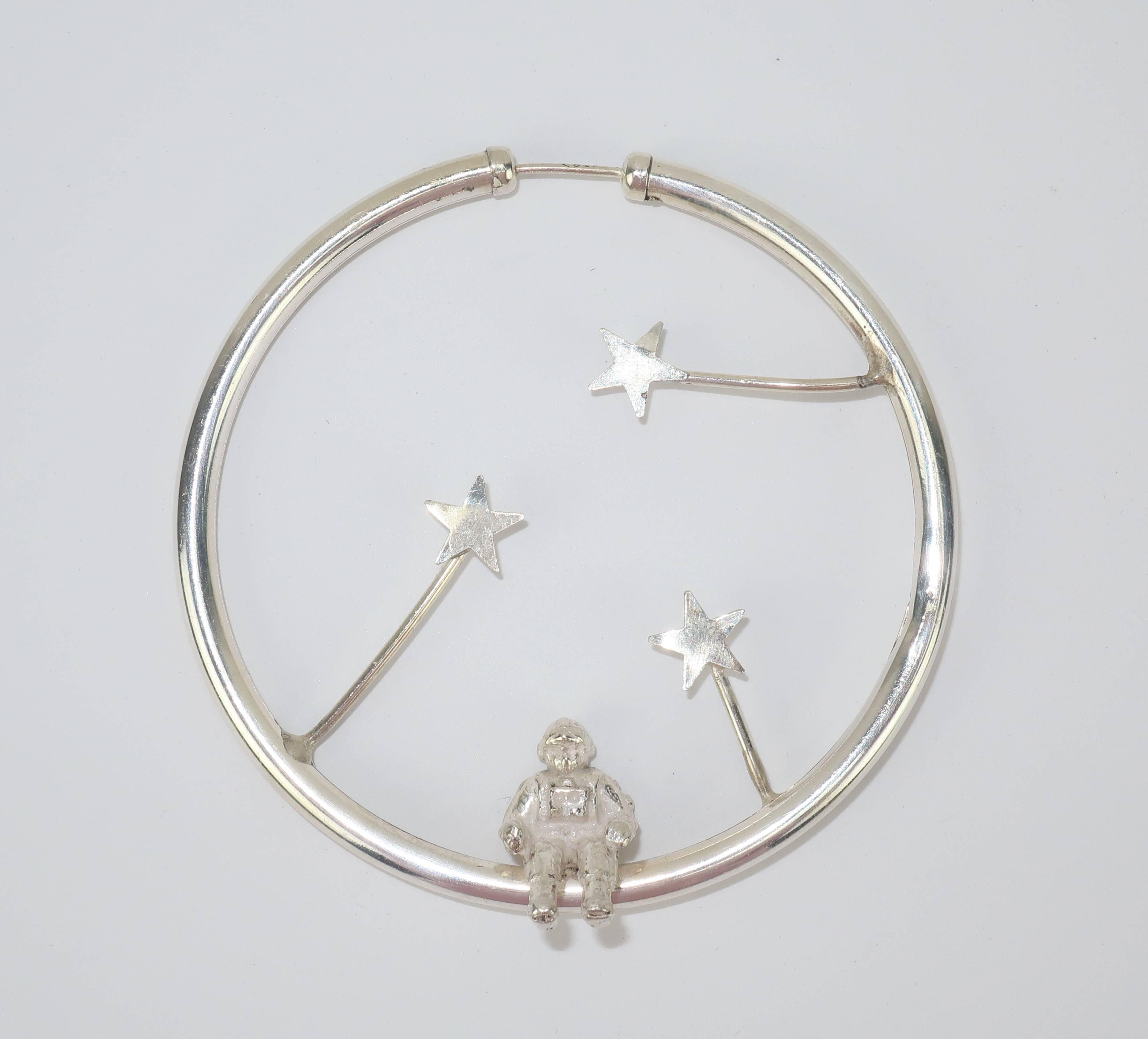 These earrings are out of this world!  The fun and fabulous 1980’s design depicts astronauts and stars all mounted on sterling silver hoops.  The pierced posts function by sliding into the hoops for a secure fit.  Perfect companions for everything