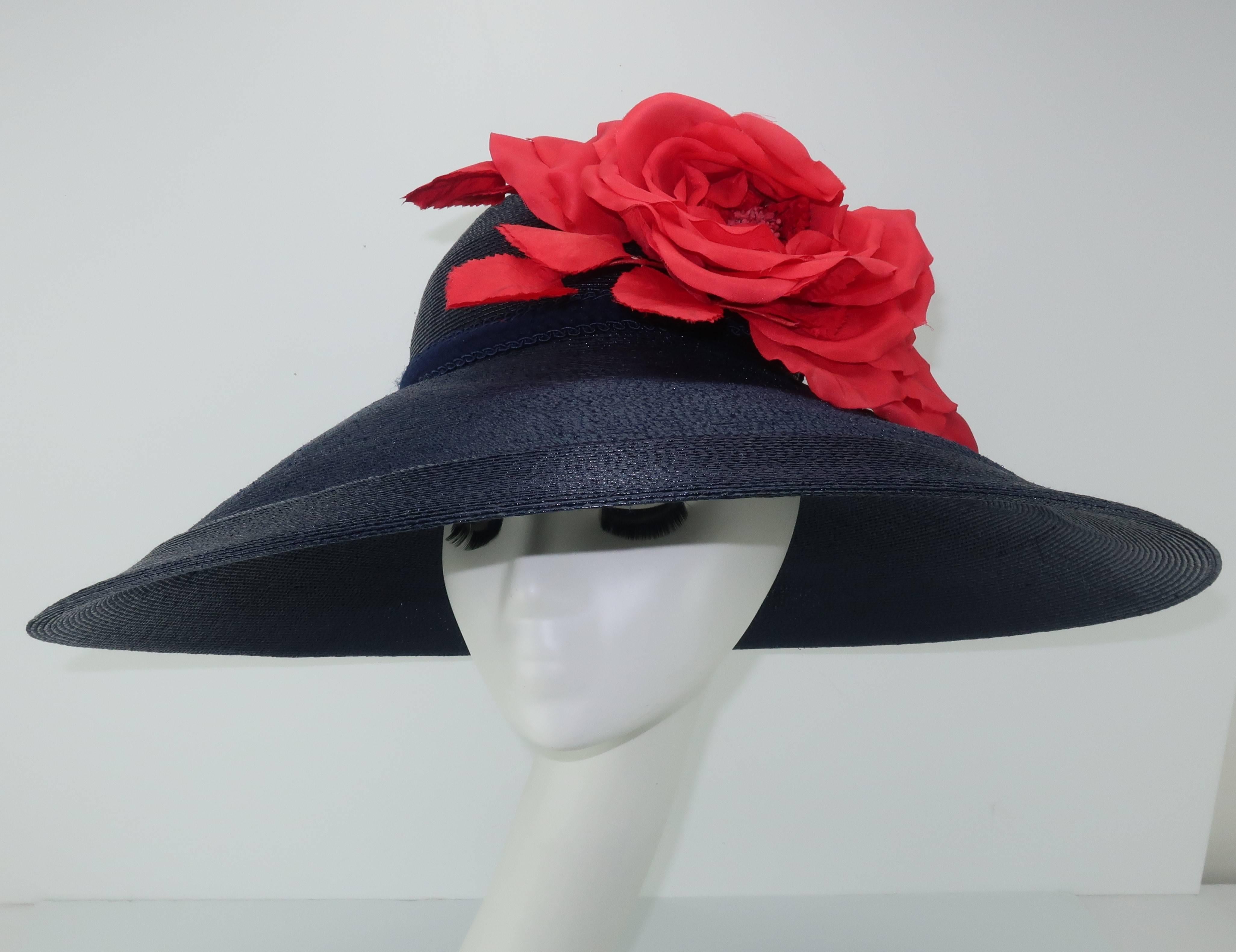 Garden party anyone?  Patricia Underwood has mastered the millinery skill of creating fashionable toppers that compliment silhouettes without too much adornment.  This wide brim blue straw hat is a bit of departure with a beautiful oversized red