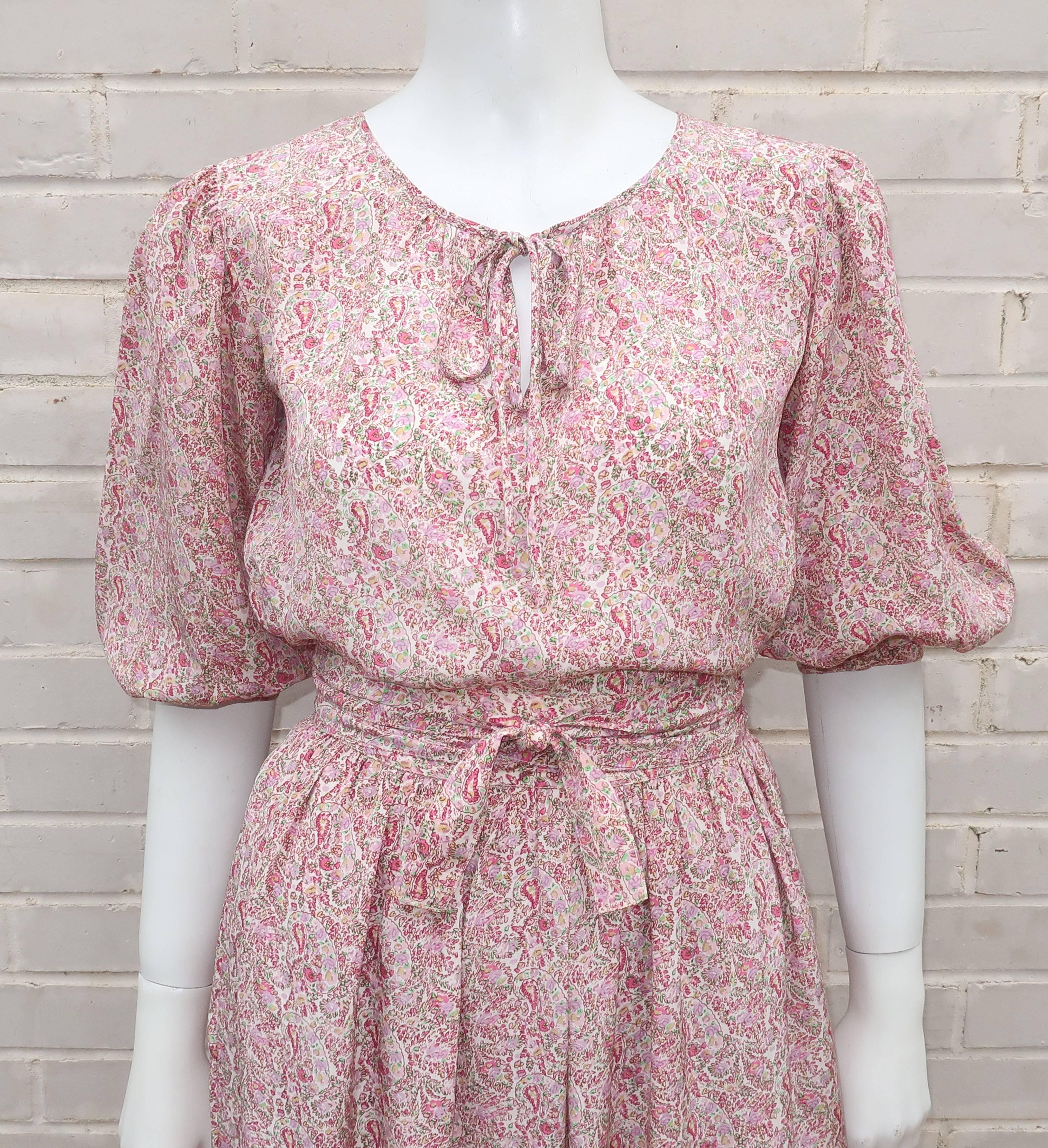 Oscar de La Renta’s knack for creating ultra feminine designs with a touch of the romantic is at play in this lovely two piece silk peasant dress ensemble.  The pullover top ties at the neck with 3/4 balloon sleeves that pool at the button cuff and