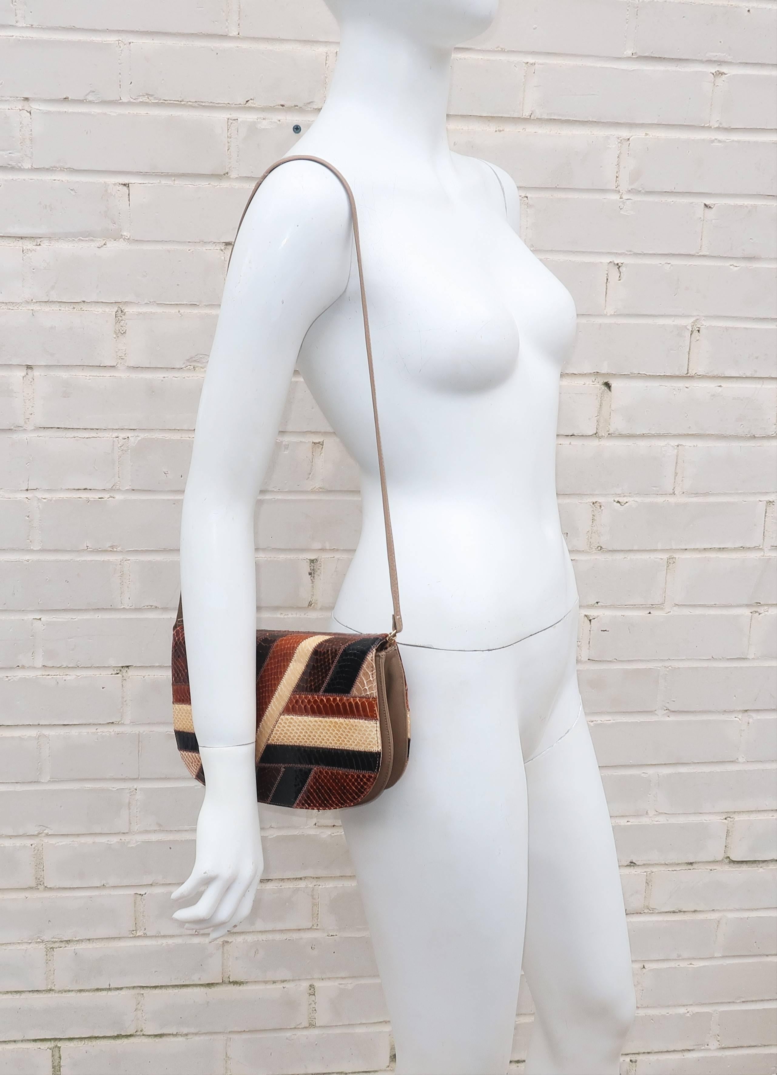 Patchwork perfection!  This 1970’s Palizzio handbag is created with various shades of brown snakeskin in an art deco revival patchwork design at the front and back.  The gusset and shoulder strap are a high quality taupe faux leather.  The strap is