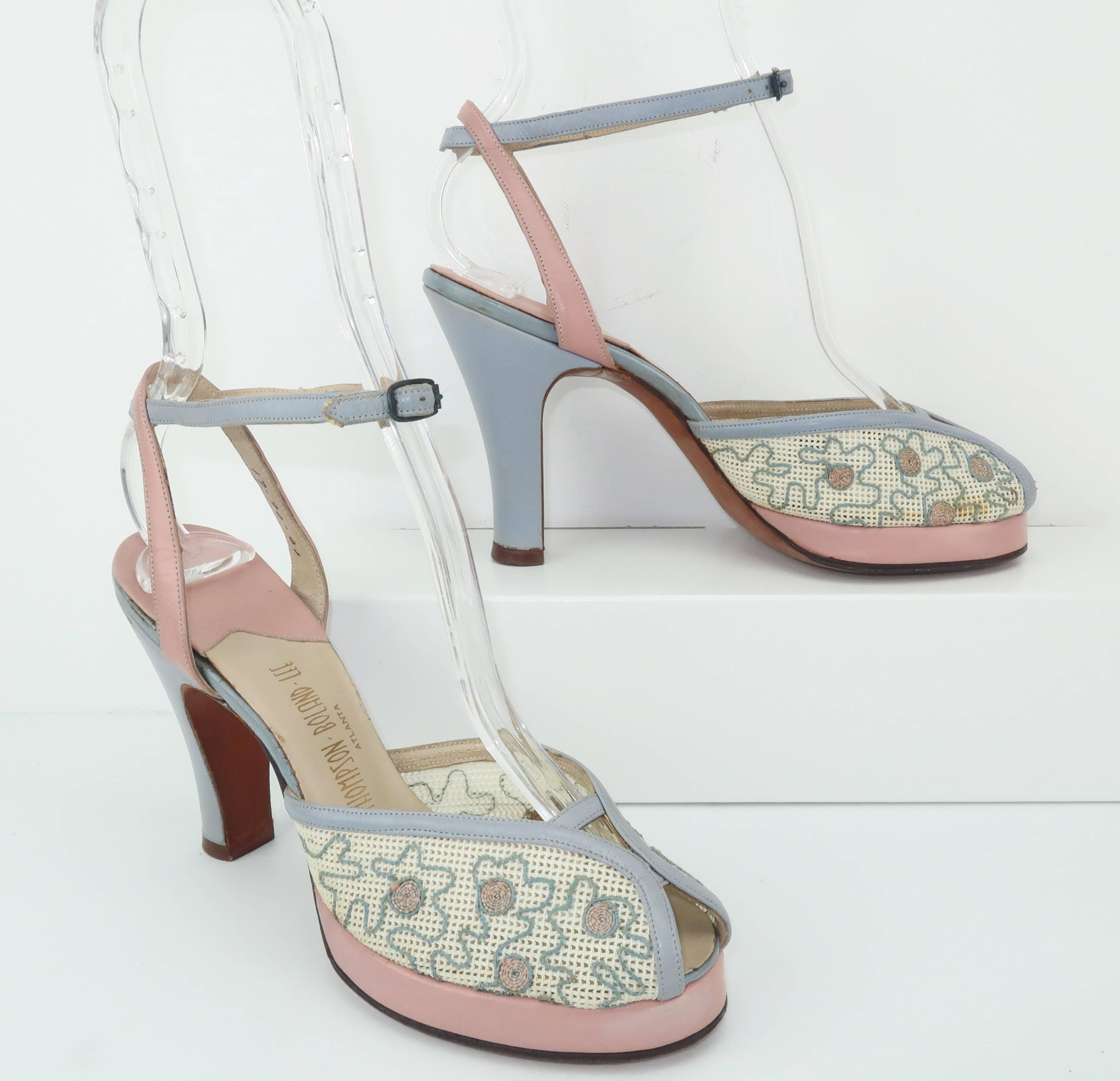 What a pleasing platform!  This pair of James Kean for Urbanites peep toe sandals are a fab combination of pink and baby blue leathers with a modest platform and adjustable ankle strap.  The vamp is decorated with cotton netting embellished with a