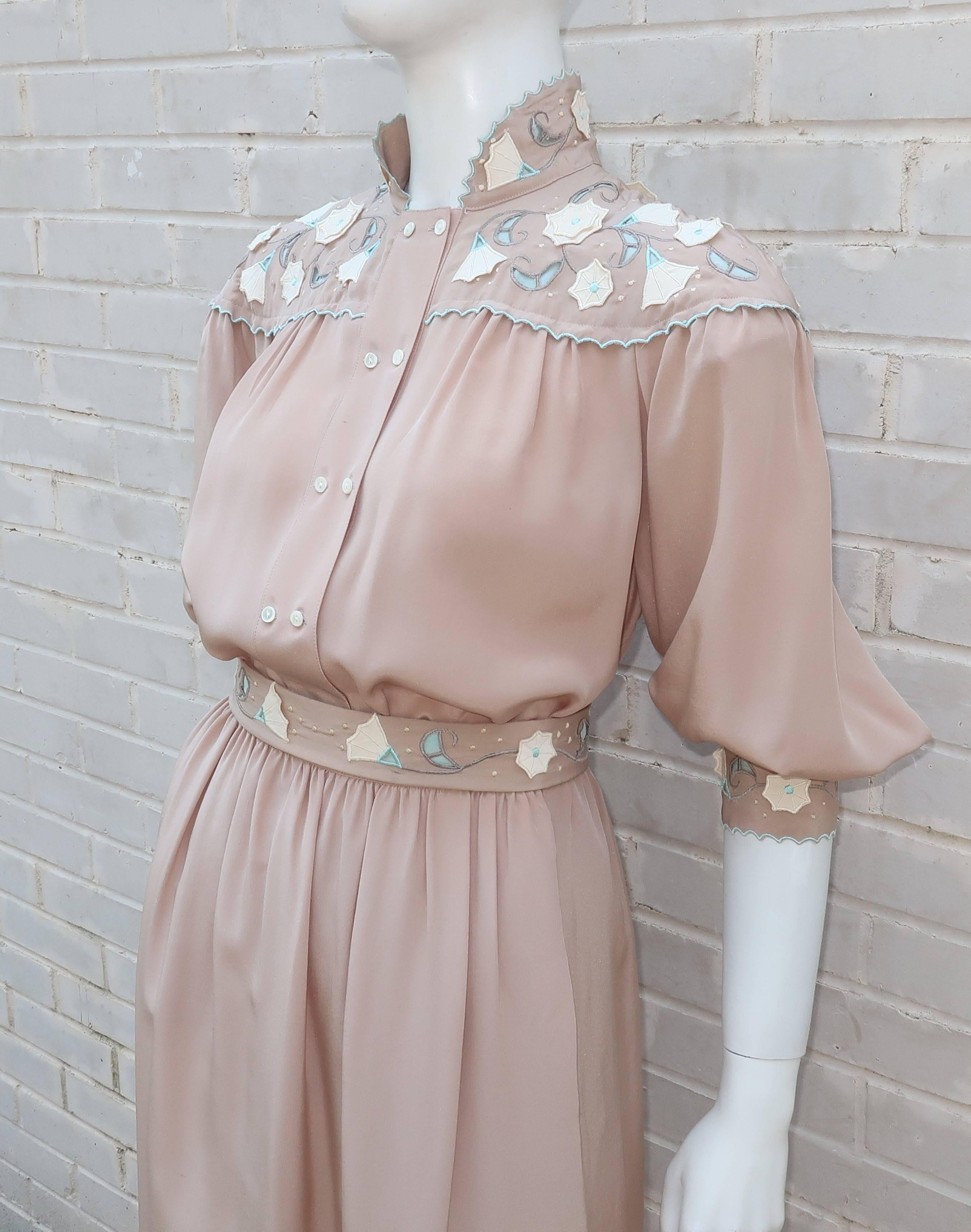 This 1980's Jerri Sherman two piece light taupe silk dress ensemble is loaded with femininity and unexpected details.  The top has a double row of small buttons with a mandarin style collar, bib and sleeve cuffs decorated with cut outs and appliques