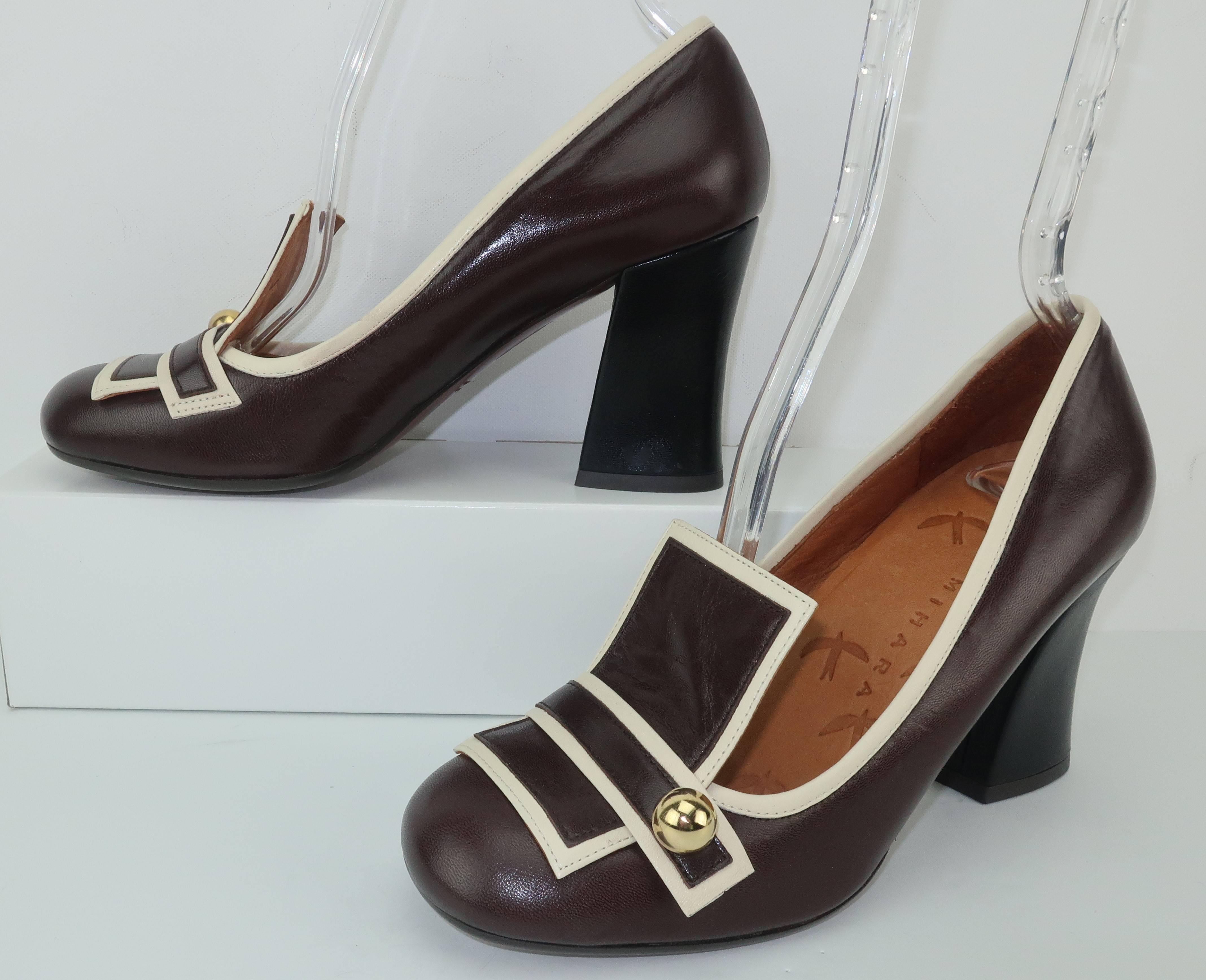 These contemporary shoes by Chie Mihara are a great homage to the fabulous mod footwear styles of the 1960's.  The two tone leather body combines a dark chocolate brown with an off-white trim in a graphic pattern embellished with a gold ball detail