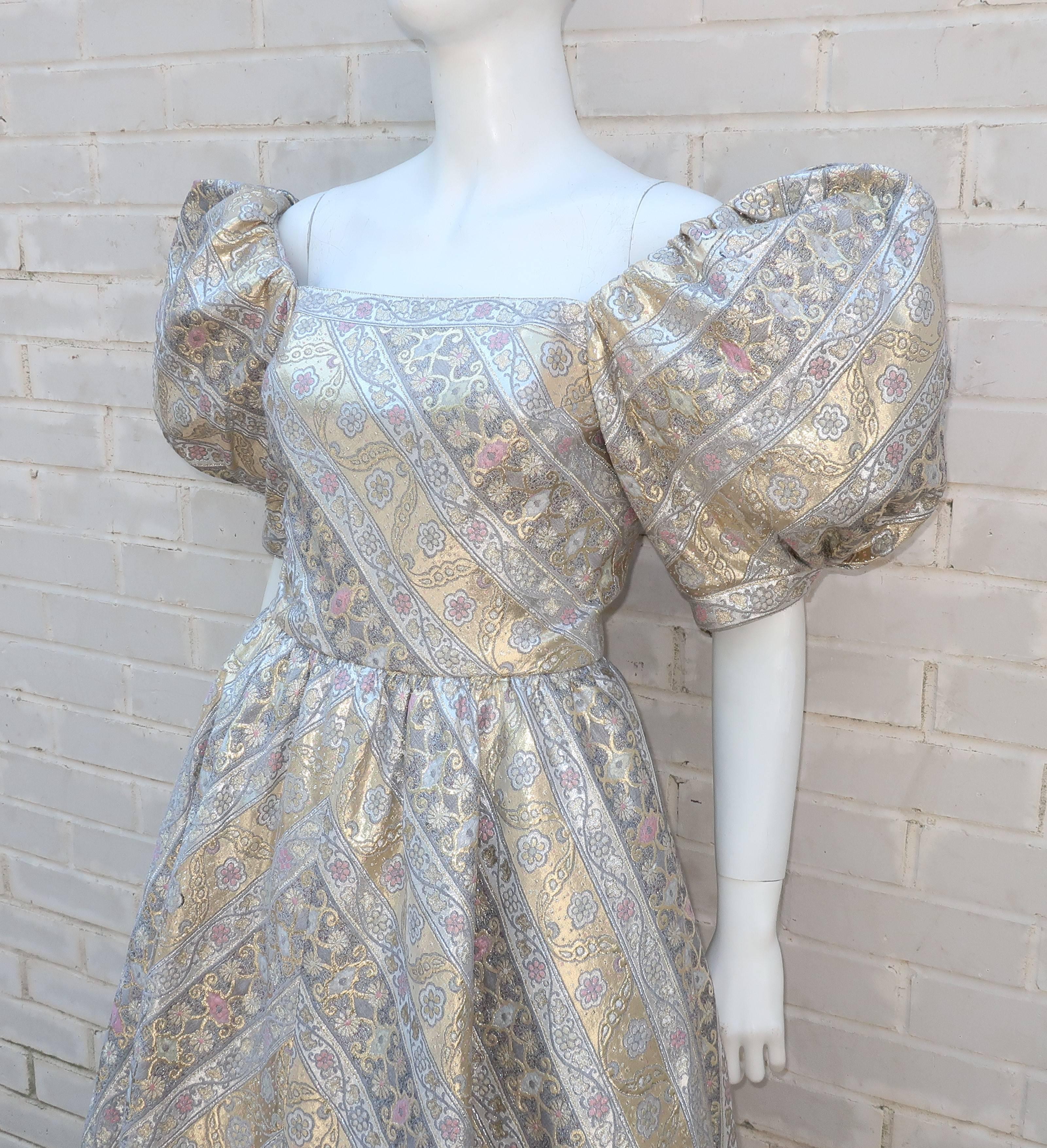 This over-the-top Leonard dress is a perfect example of the drama and opulence of fashion in the 1980's.  Created from a luxurious metallic brocade fabric, the fitted bodice is offset by voluminous balloon sleeves that are expertly cinched at the