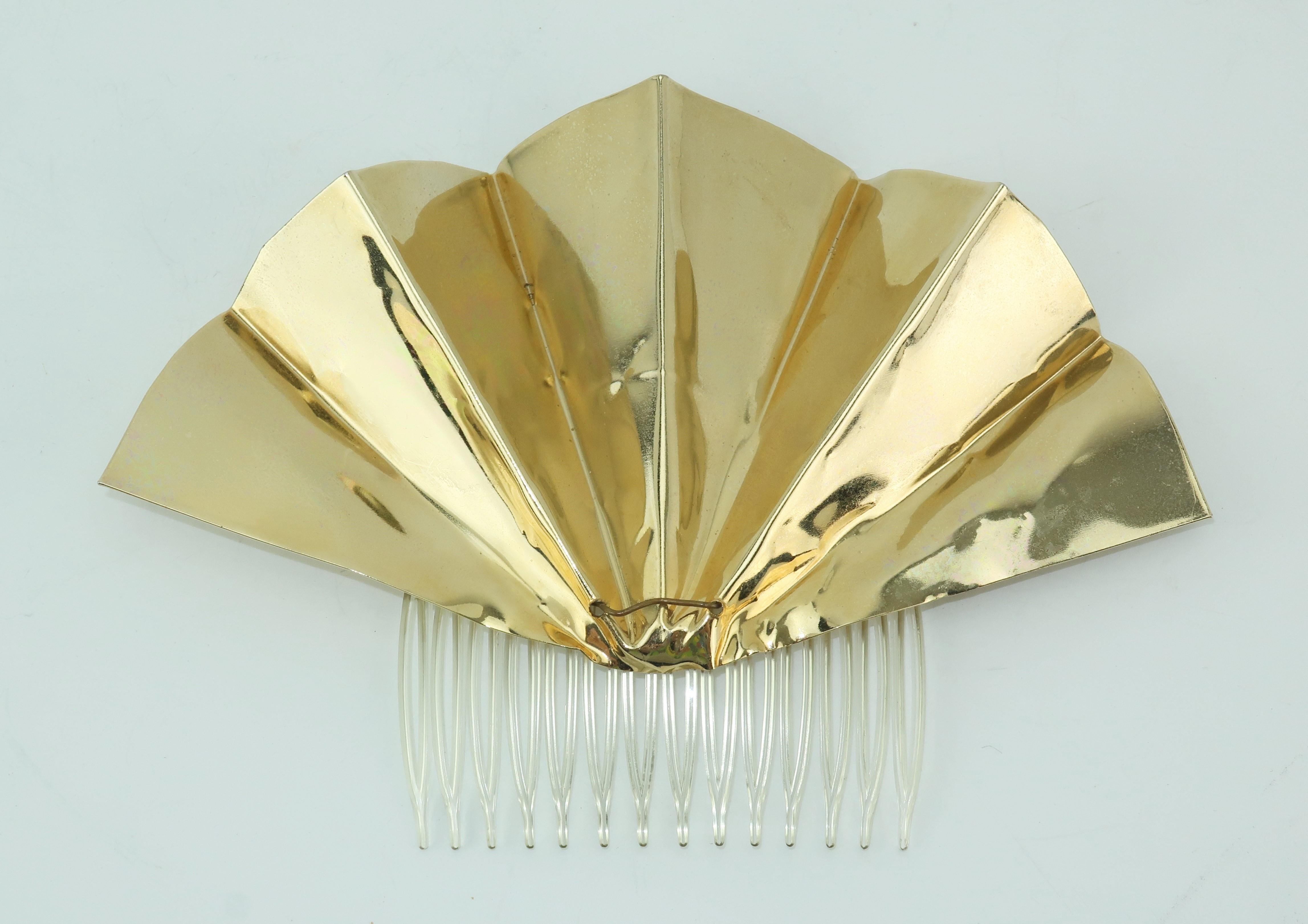 This jewelry style gold metal fan hair ornament by Lee Menichetti, a designer known for creative fashion accessories as well as sculptures and jewelry inspired by opera productions, is a piece of wearable art and perfect for adding a 1970’s disco