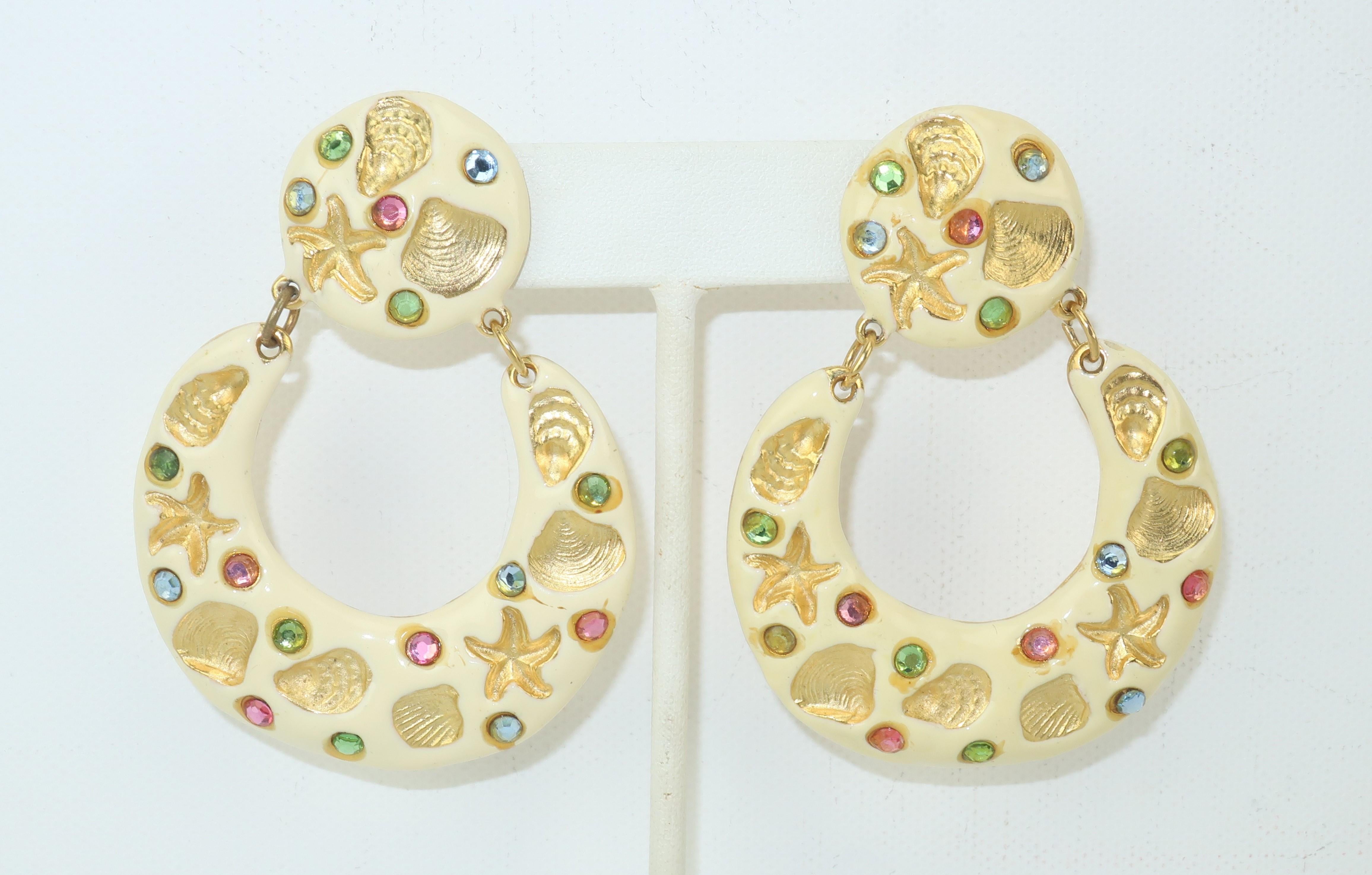 She sells seashells by the sea shore ... all while wearing stylish 1970’s Gem-Craft earrings by Gene Verri!  The clip on earrings feature an articulated drop hoop fully decorated in a creamy off-white enamel with shell and starfish impressions