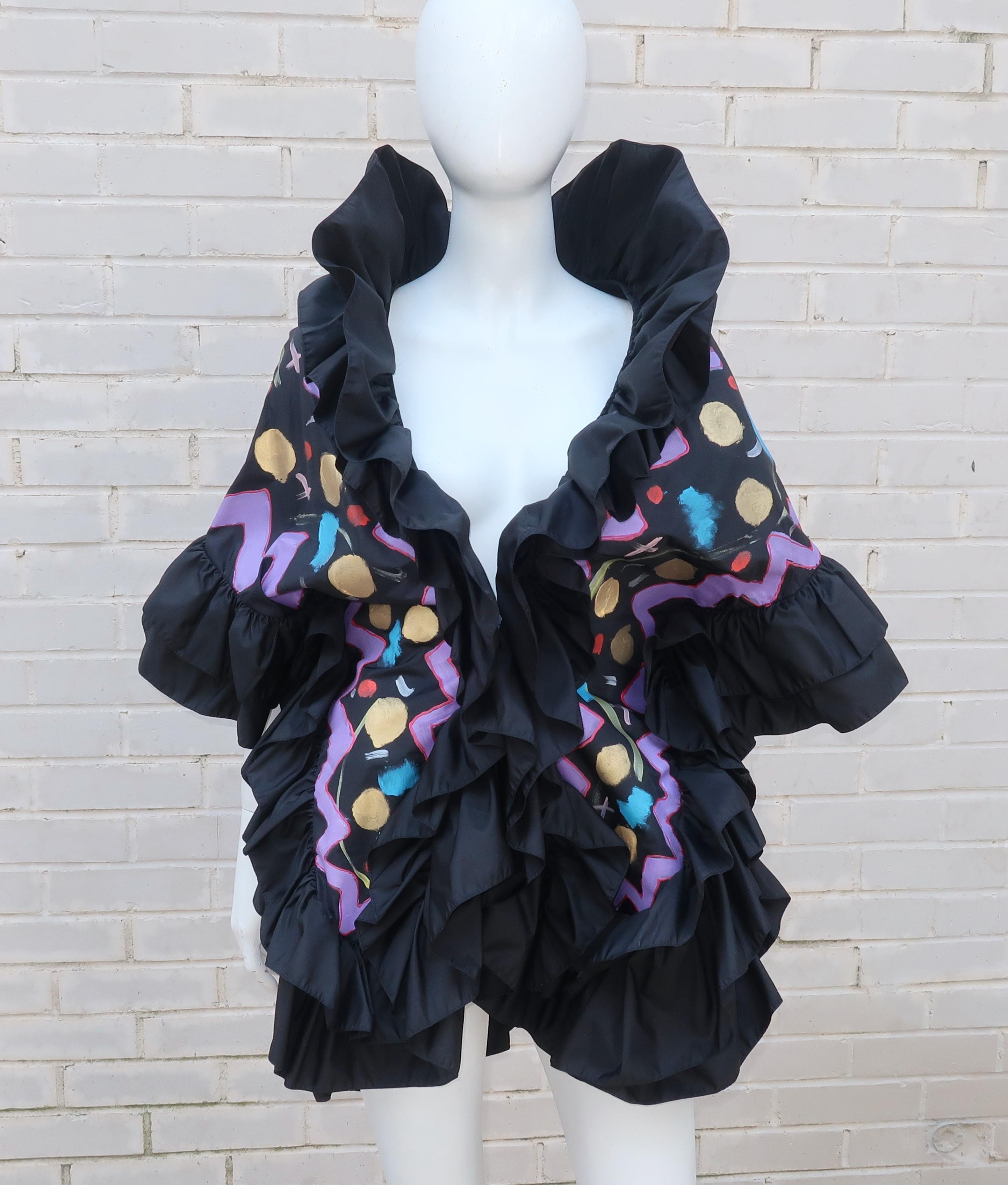 This taffeta wrap looks like a party all on its own.  The black background is the perfect canvas for a hand painted celestial style design featuring shades of gold, silver, electric blue, purple, peach and red.  The jacket silhouette is accented by