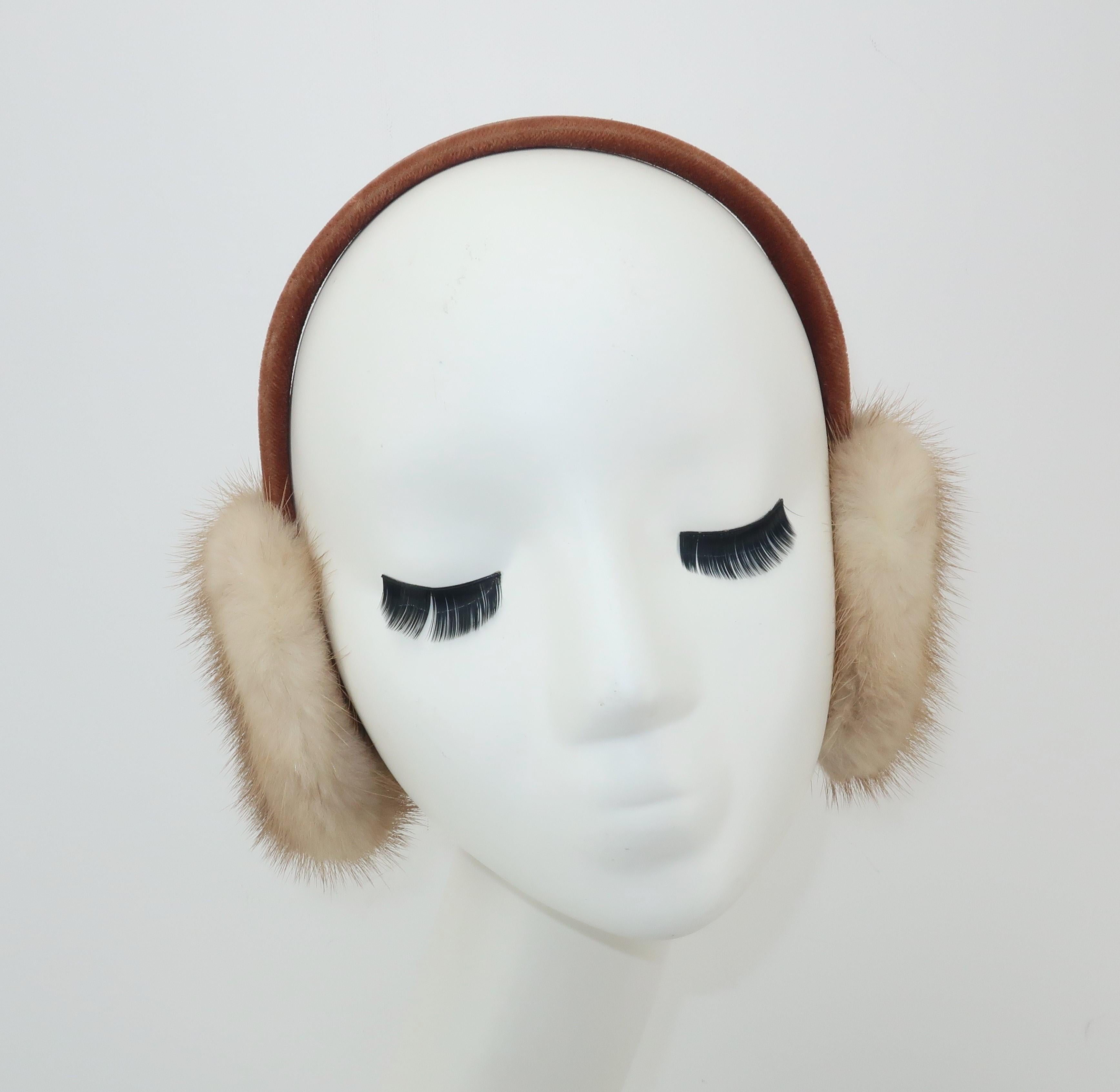 What an adorable way to fend off the winter chill!  These vintage ear muffs are fabricated from blonde mink fur and a light brown velvet covered headband.  Very good condition with light wear to the velvet fabric at the edges of the band as shown in