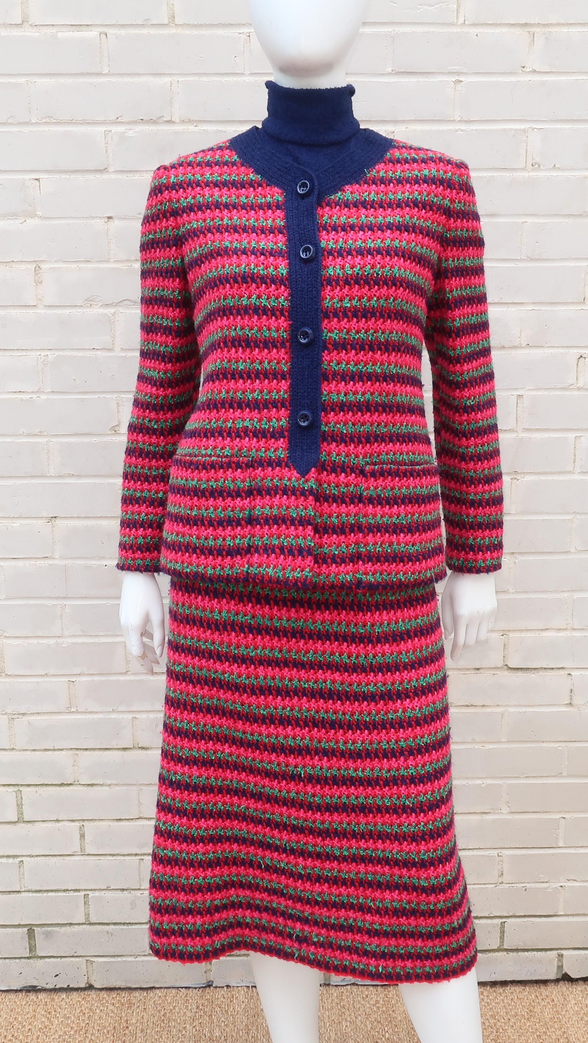 This three piece ensemble from Murrell is hand crocheted with a bright mix of colorful looped knits and the set consists of a short sleeved mock turtleneck top in navy blue and a skirt with cardigan jacket in shades of blue, raspberry red, pink and