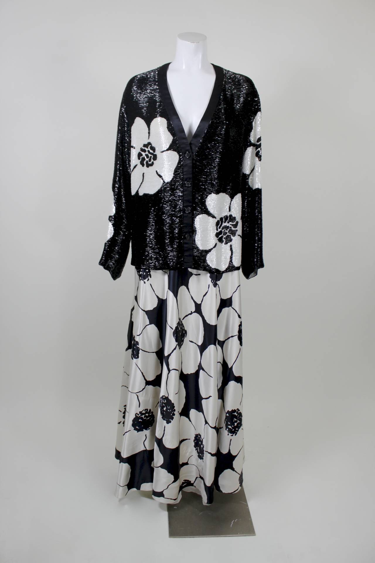 A gorgeous evening ensemble from renowned American designer James Galanos. The top, a cardigan silhouette, is completely covered in dense bugle beading in a floral motif. While slightly oversized, the cut of the top is still sexy and chic.