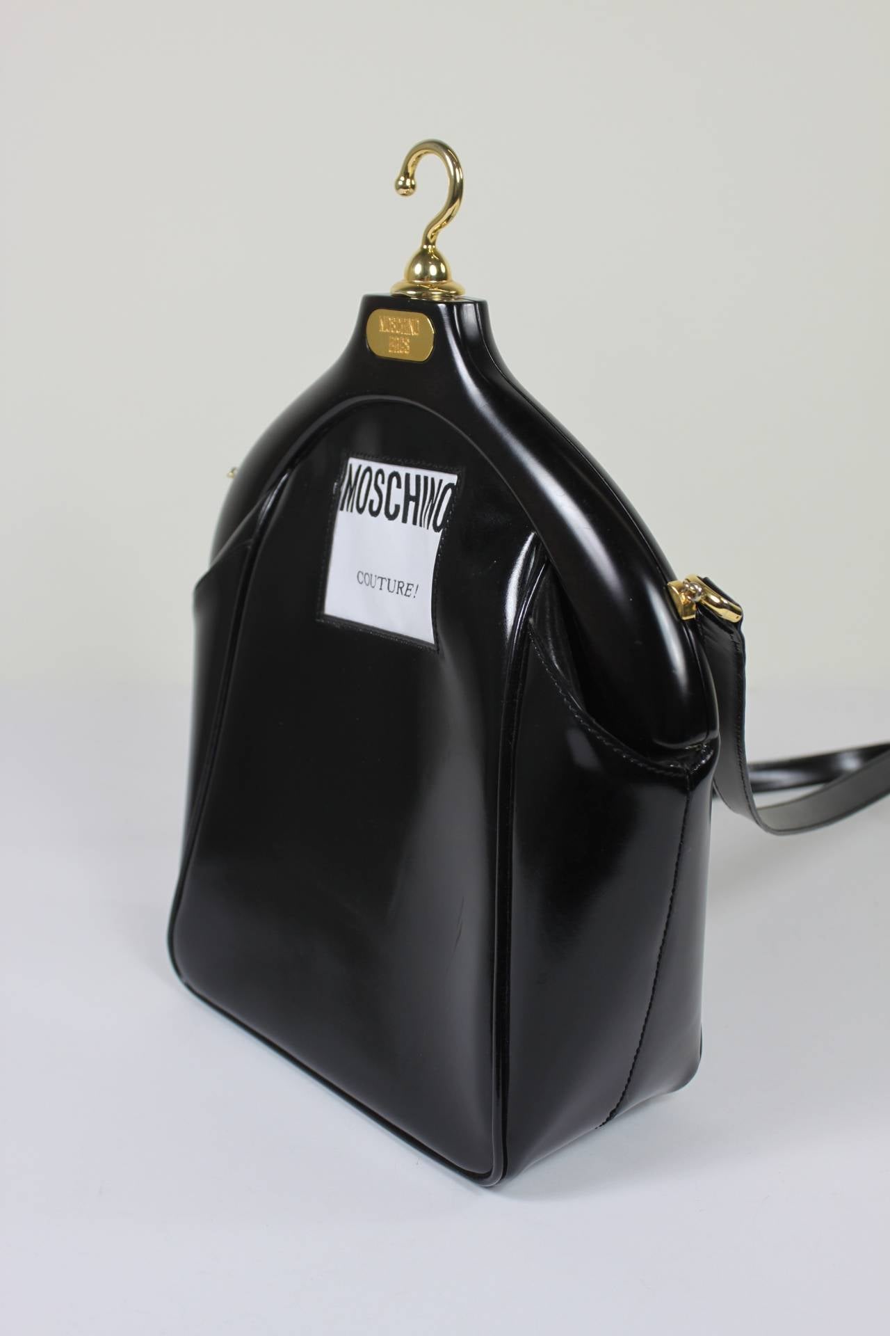 MOSCHINO Couture! Iconic Hanger Motif Leather Purse

Measurements--
Base: 7.5 inches x 3.75 inches
Height, Base to Bottom of 