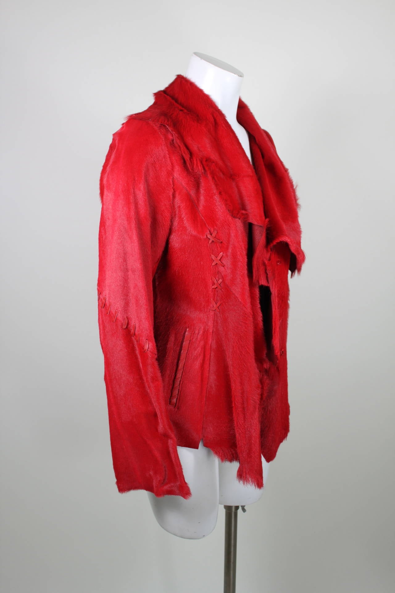 A gorgeous lipstick red asymmetrical lamb fur jacket from Via Veneto.

Measurements--
Bust: up to 36 inches
Waist: up to 31 inches
Length, Shoulder to Shoulder: 15.5 inches
Sleeve Length: 25 inches
Length, Center Back to Hem: 24 inches