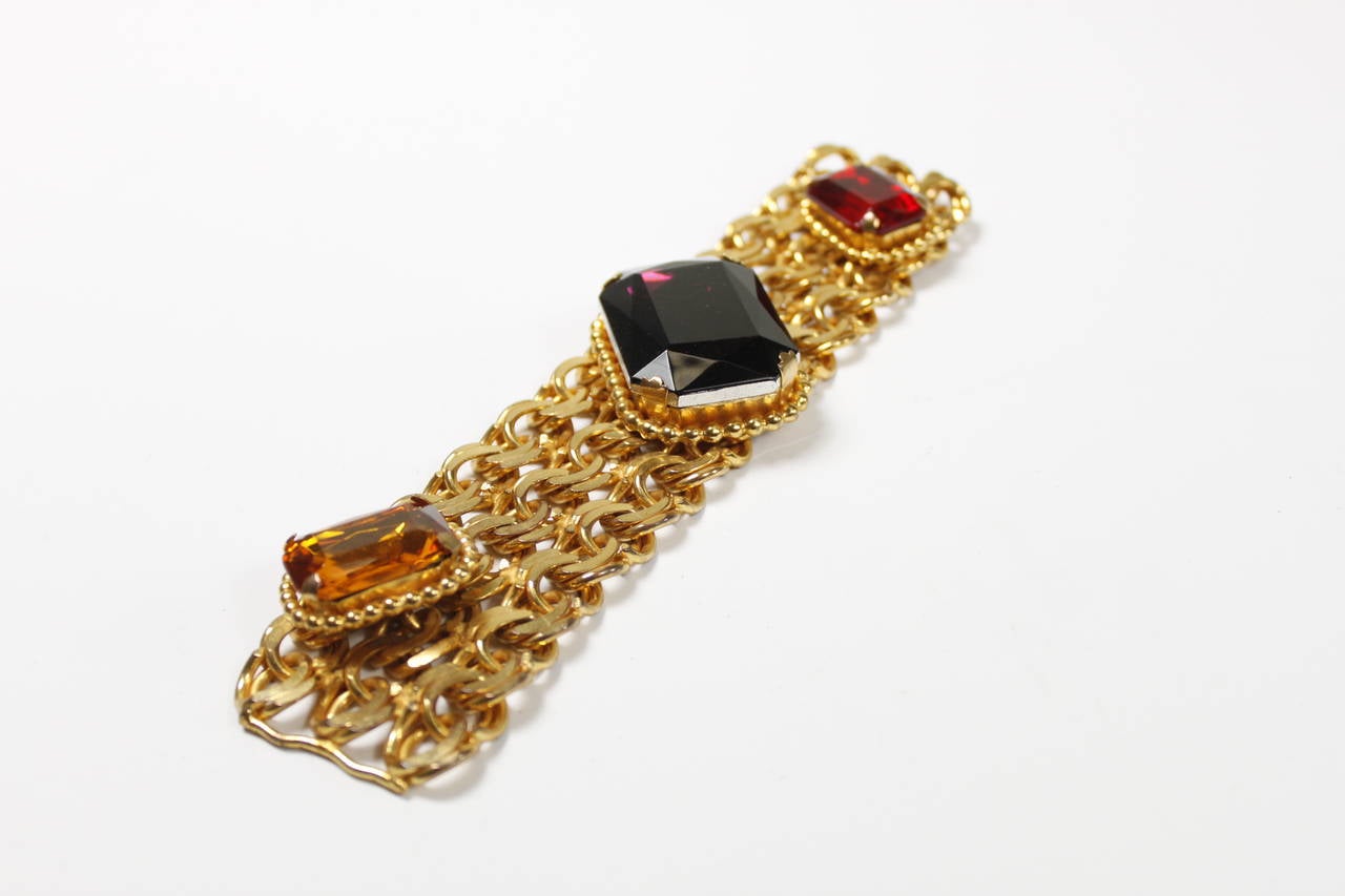 A gorgeous piece of statement costume jewelry from Dominique Aurientis. Gold tone double-link chain is embellished with three large, vibrant rhinestones. 

Measurements--
Length: 7.25 inches
Width: 1.75 inches