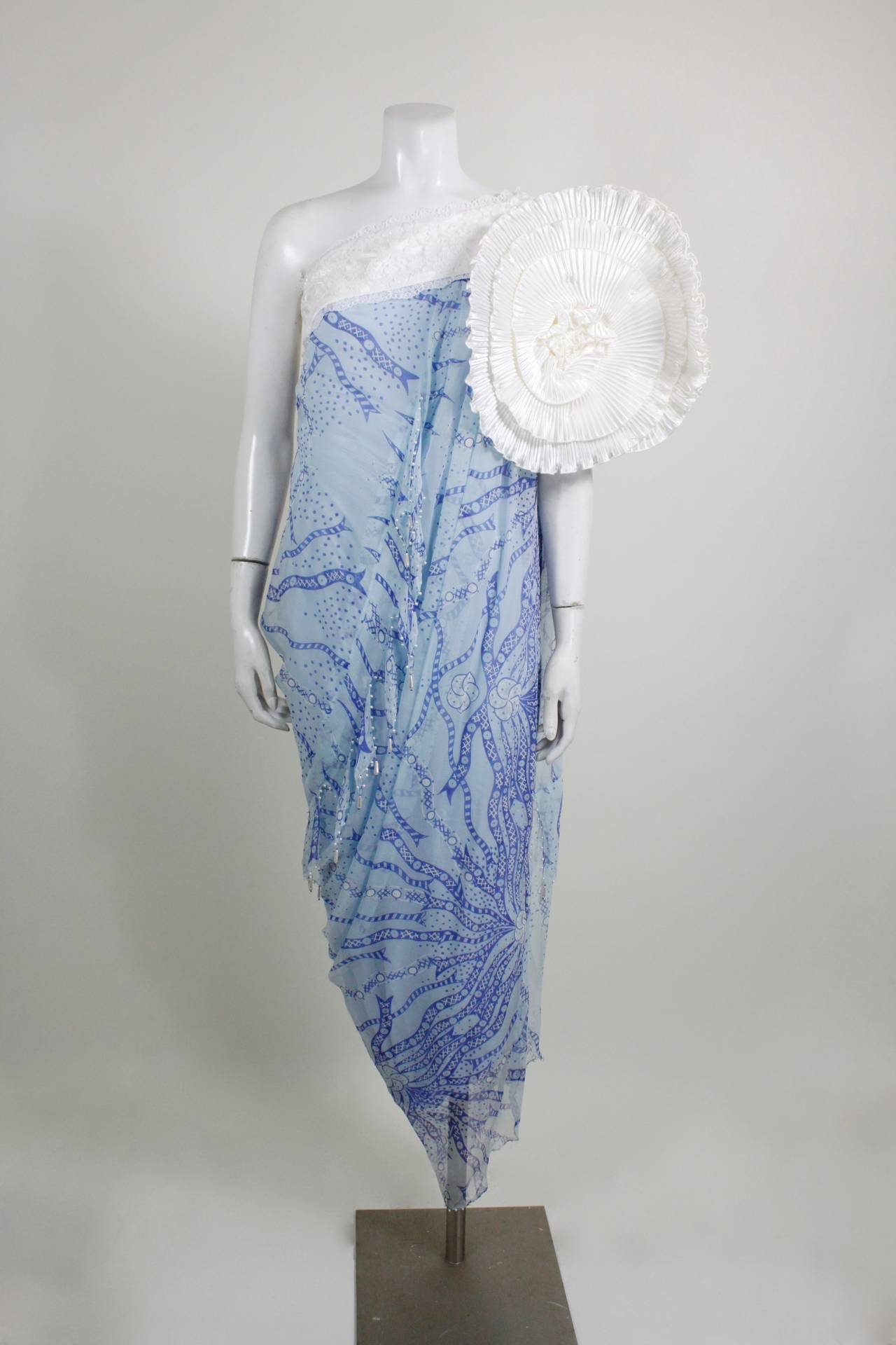 1980s Zandra Rhodes Asymmetrical Evening Gown One shoulder with oversized  applique on draped blue printed chiffon. With dangling pearl fringe. Small repair - step through at longest part of hem - not noticeable when worn.